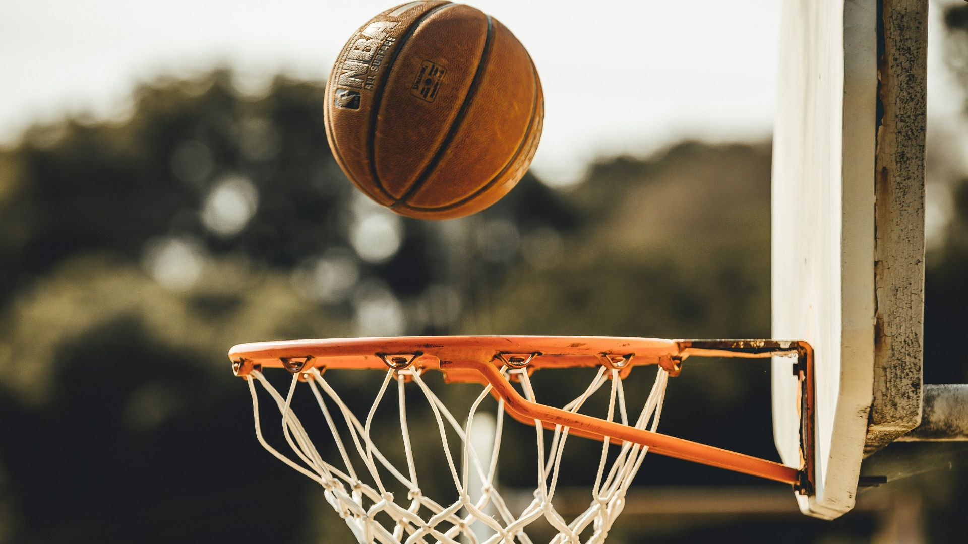 brown basketball on basketball hoop