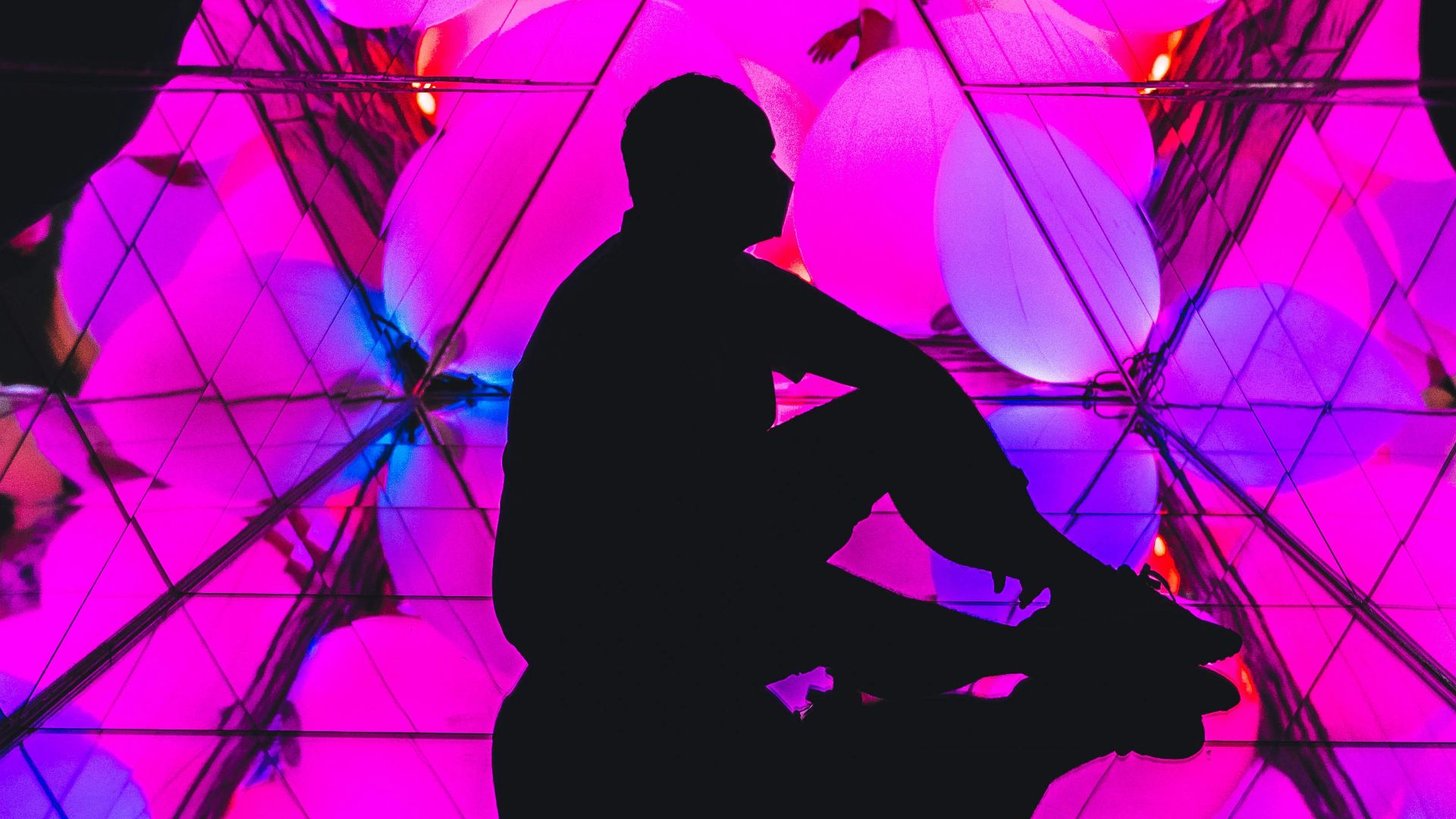 silhouette of man and woman standing on yellow and blue background