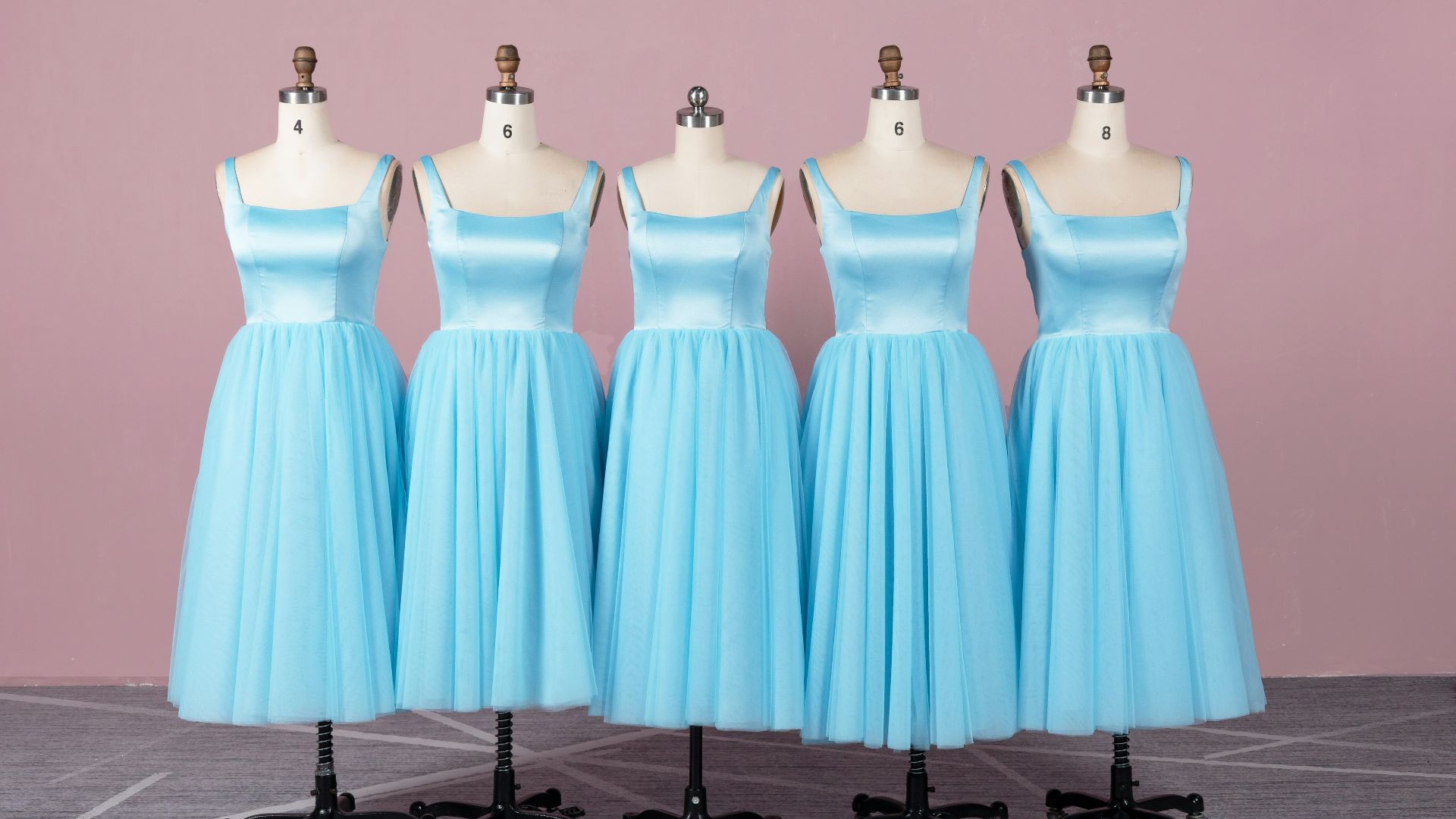 a line of blue bridesmaid dresses on mannequins
