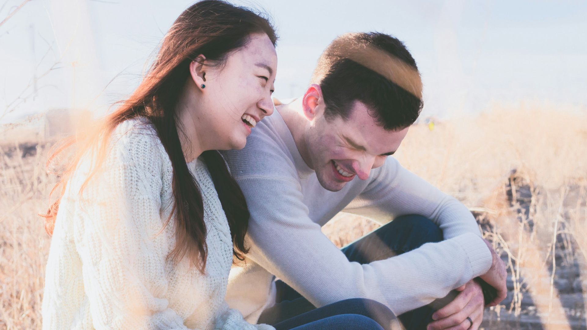 photo of man and woman laughing during daytime