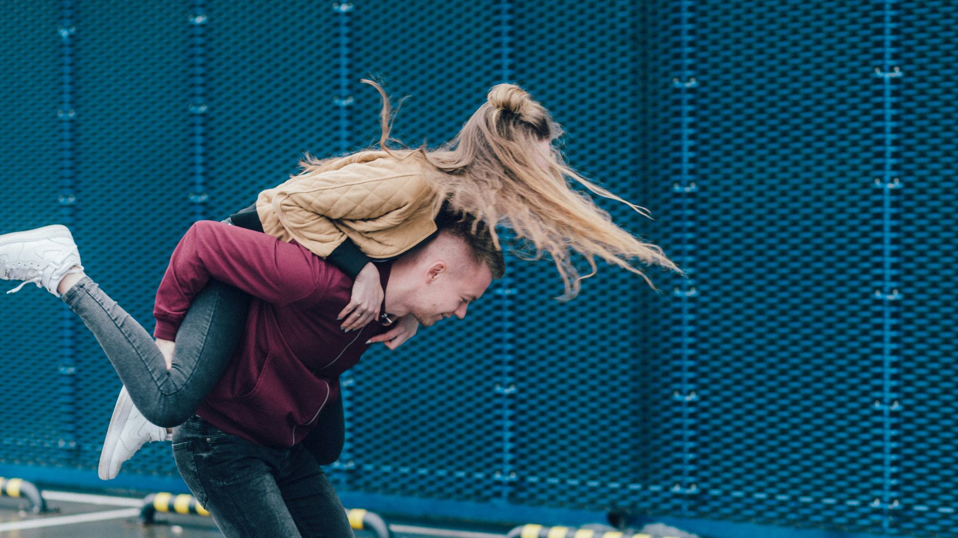 man carrying woman on back