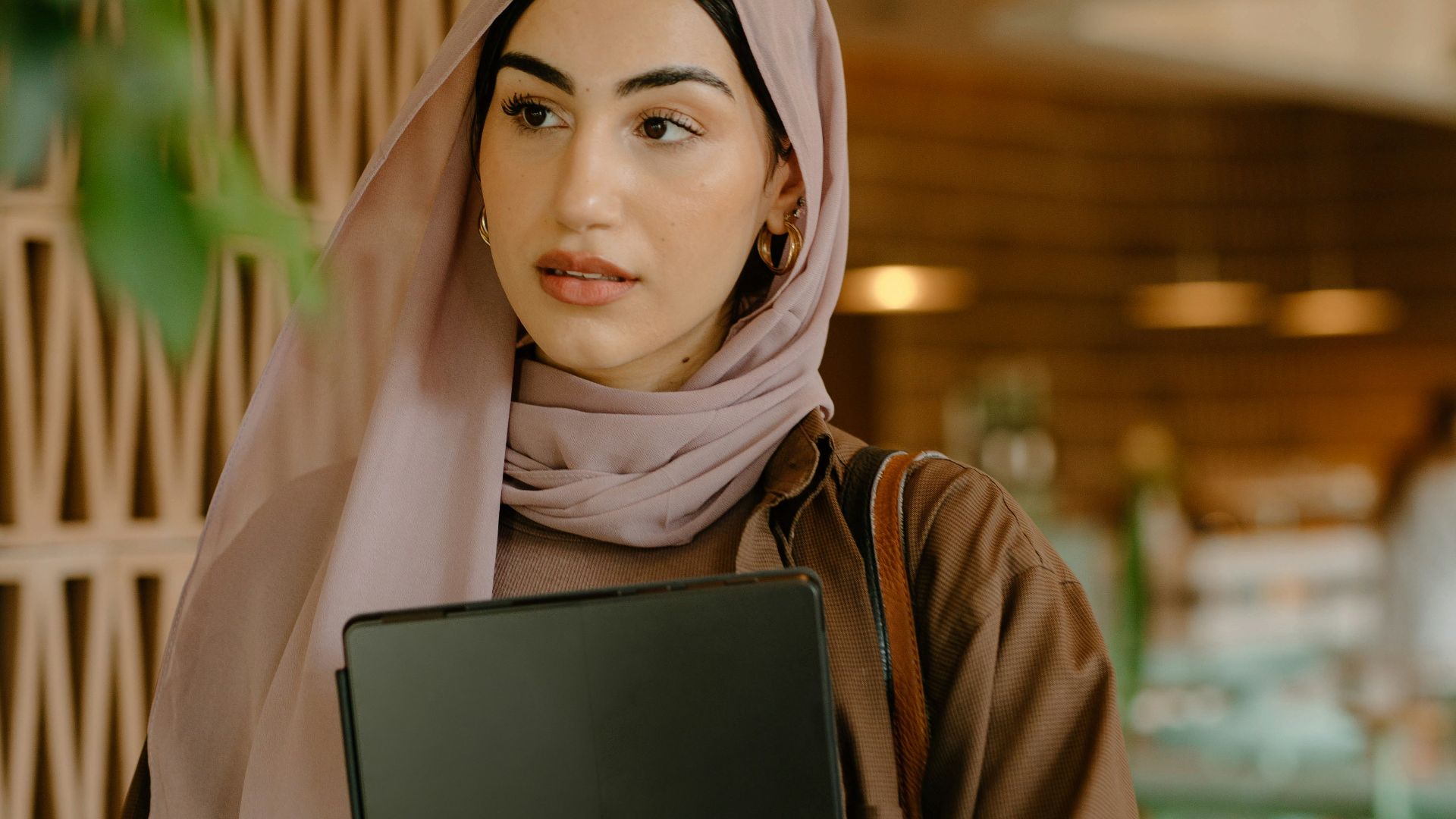 a person holding a laptop