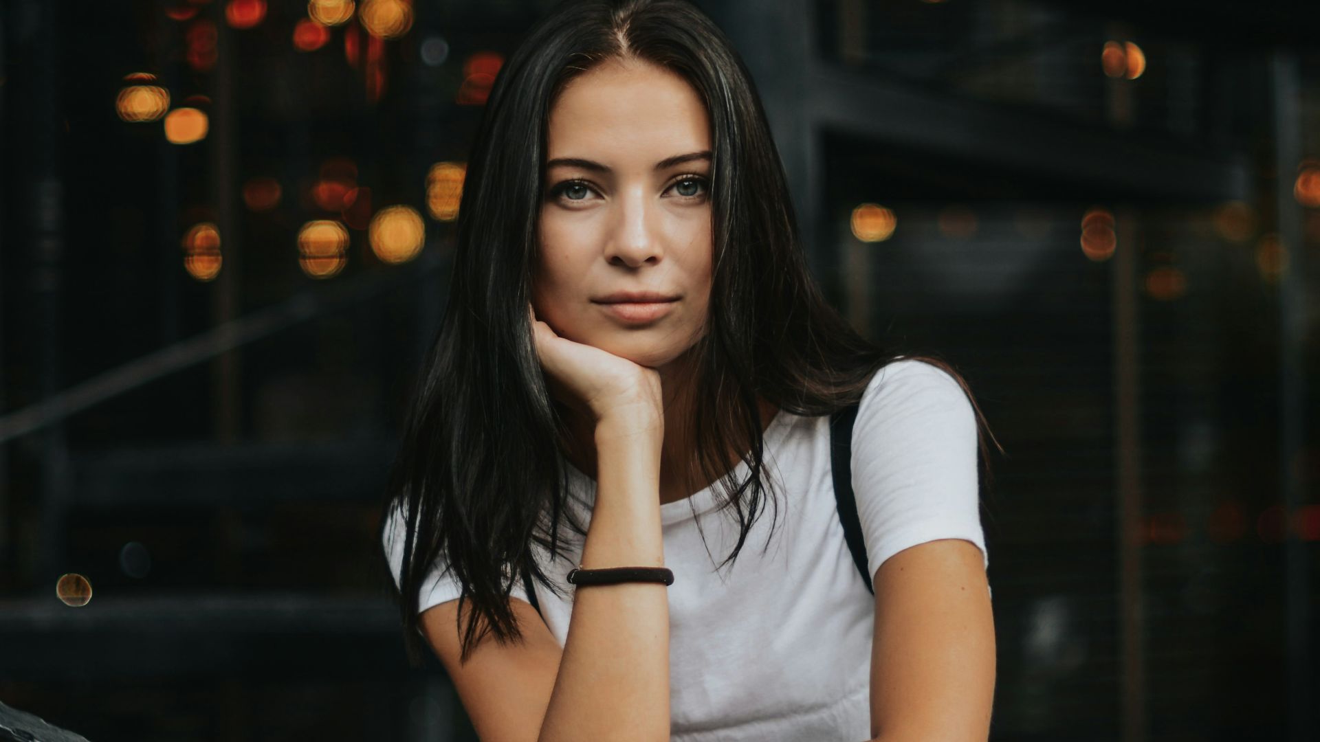 woman leaning on black handrail