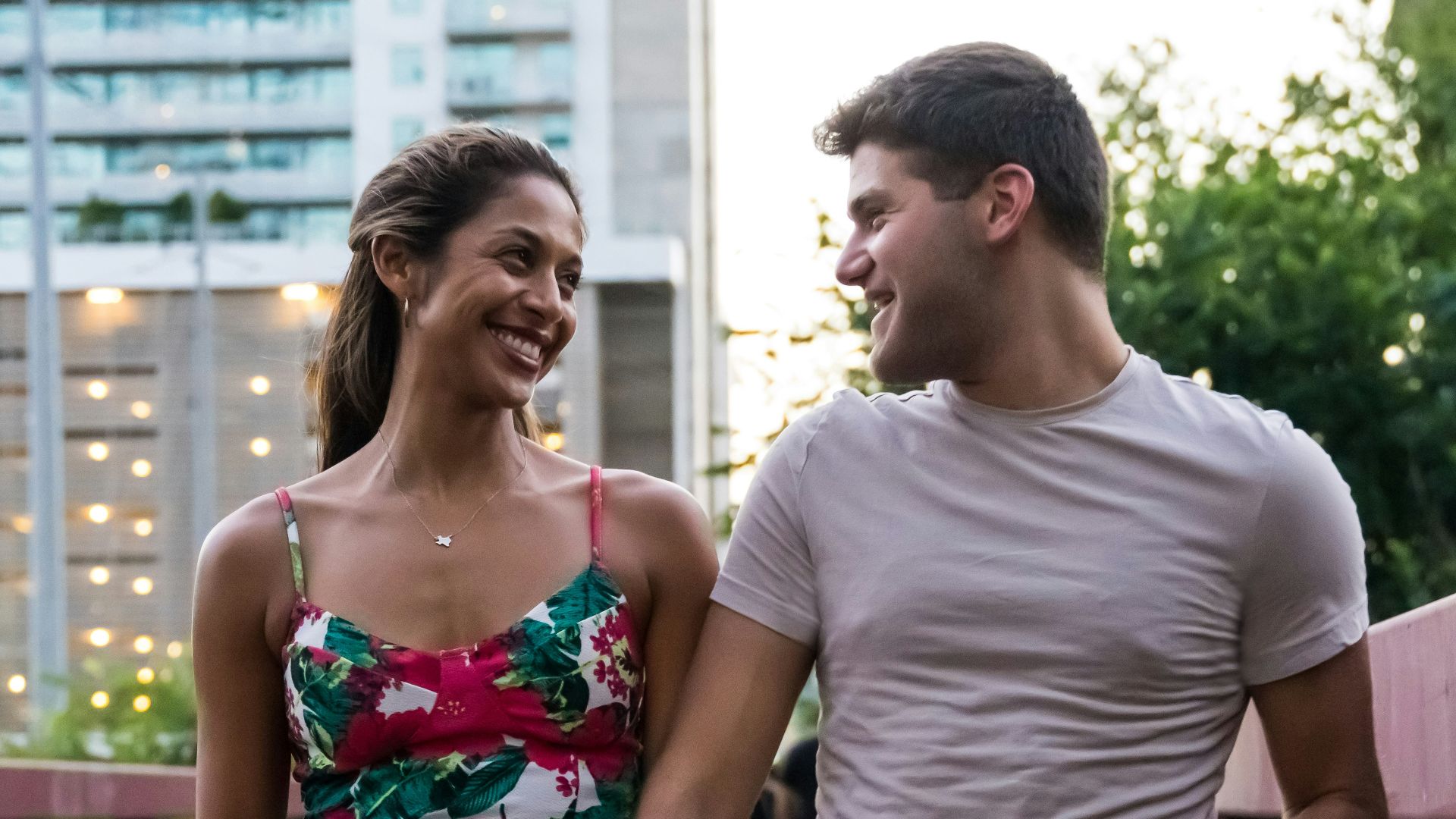 man and woman standing on wooden bridge during daytime