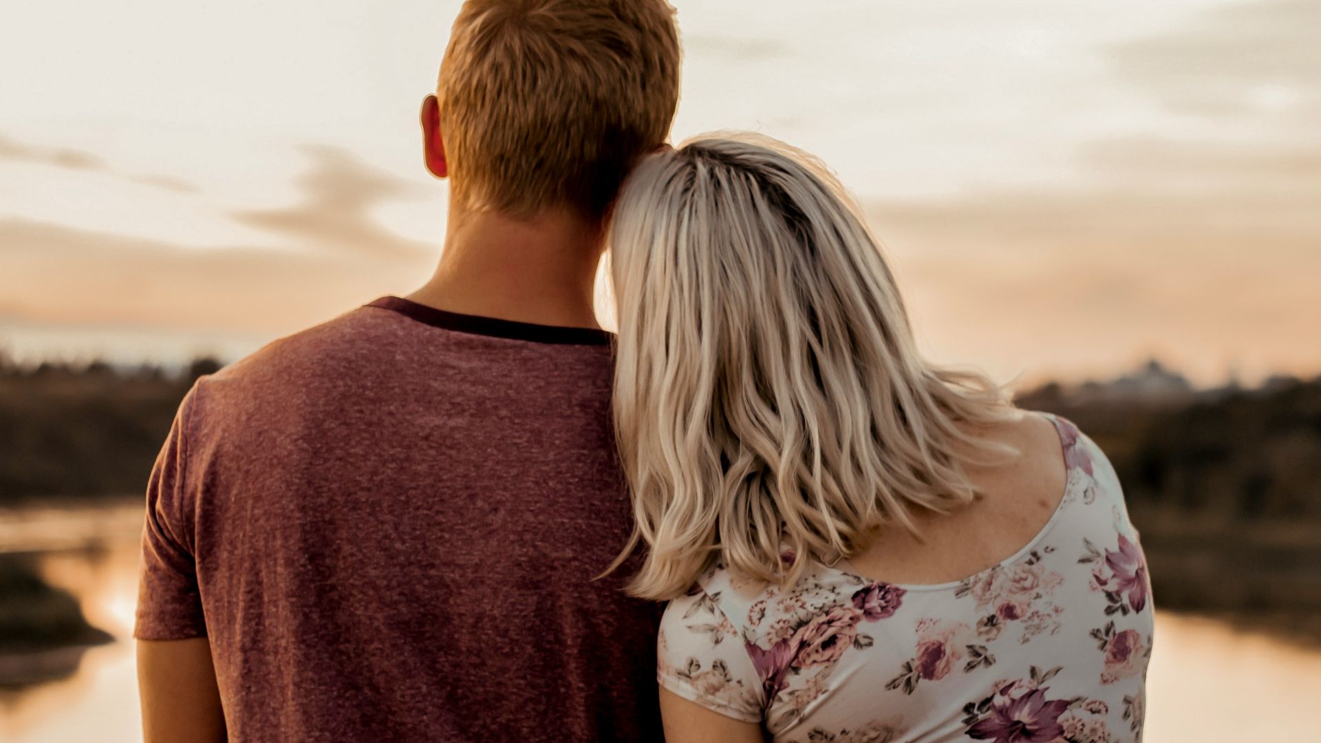man and woman standing on brown field during daytime