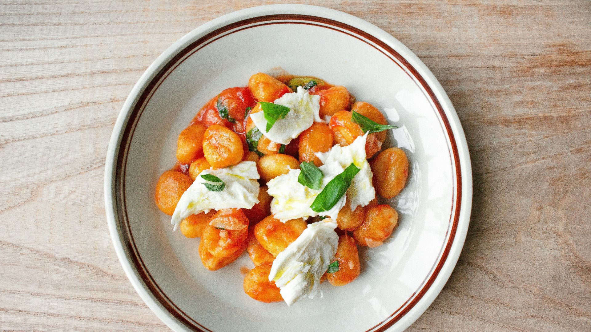 a white plate topped with food on top of a wooden table