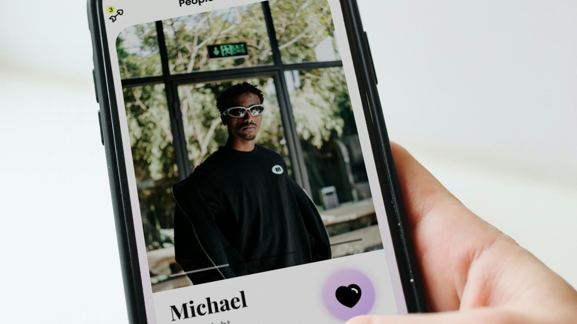 a person holding a cell phone with a picture of a man on it