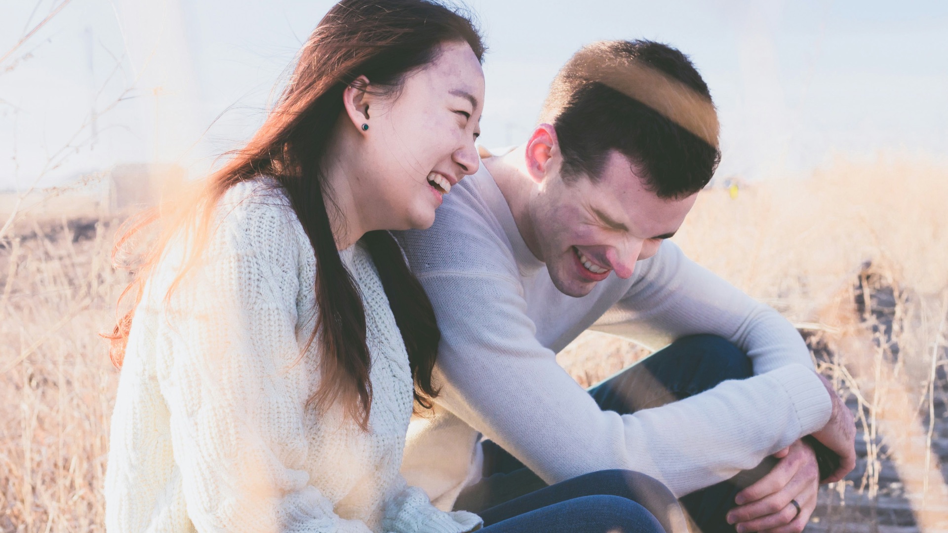 photo of man and woman laughing during daytime