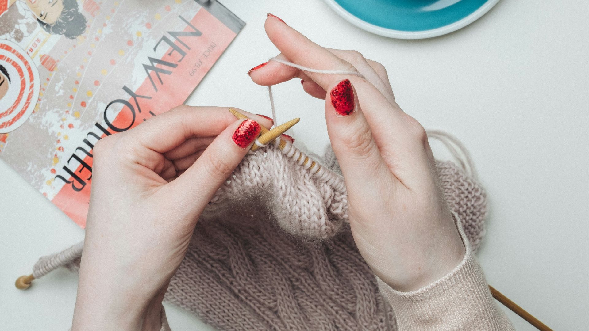 person knitting beige garment