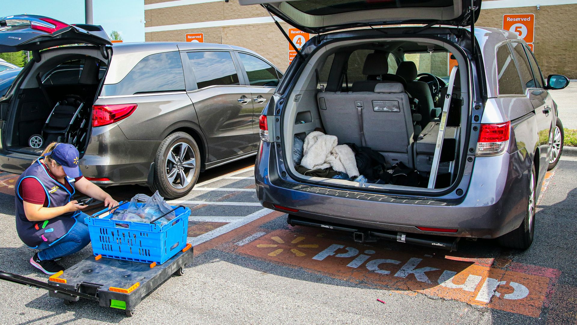 silver suv with blue plastic crate