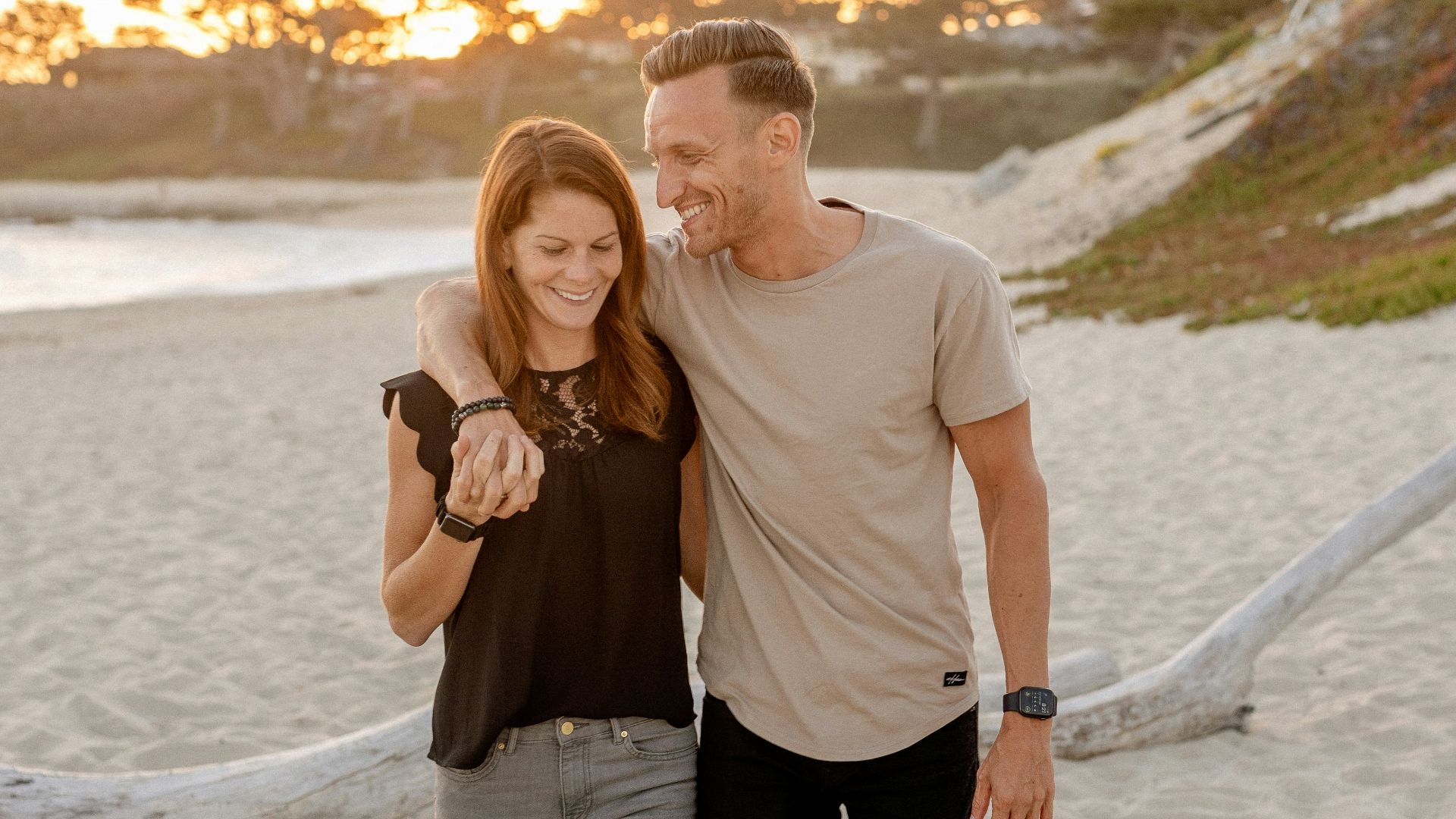 man and woman standing on beach during daytime