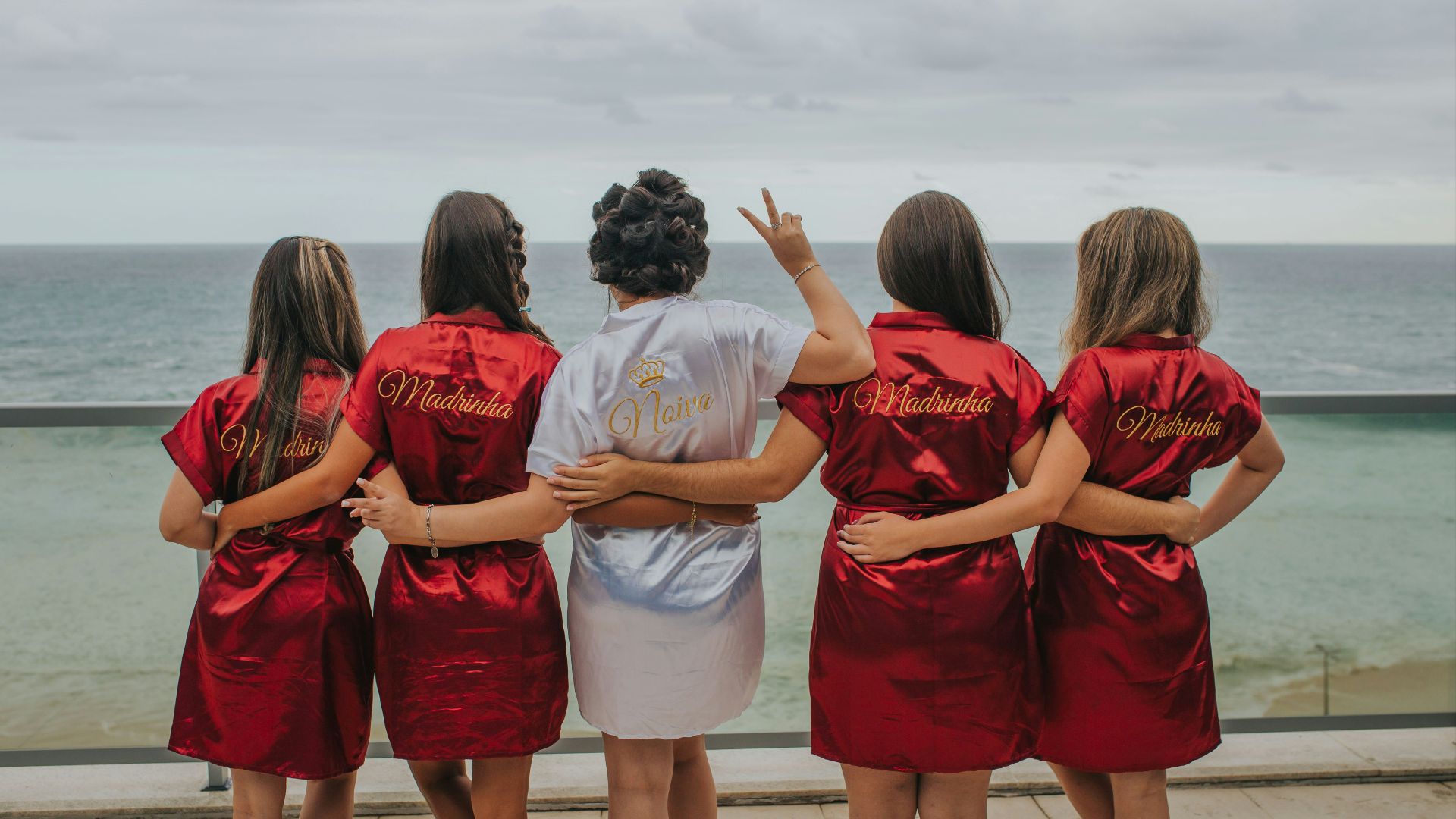 brides and bridesmaid looking at the back