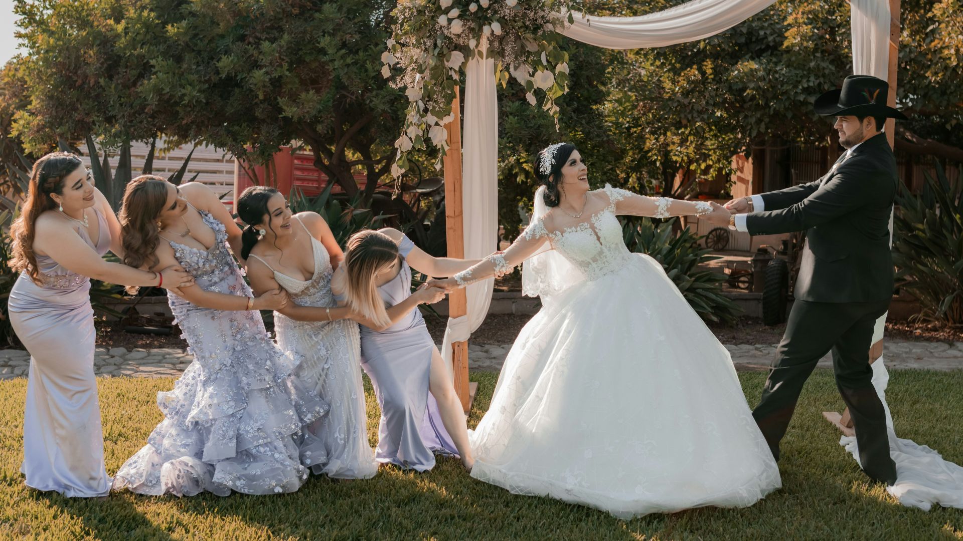 A group of people standing around a bride and groom