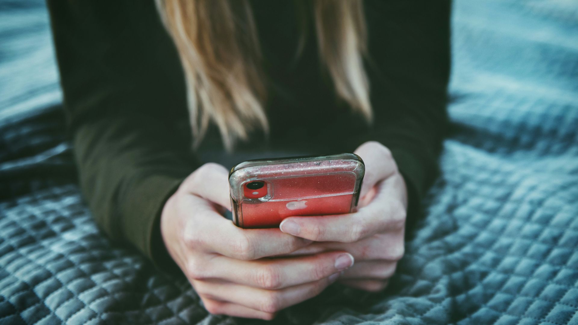 woman holding red and silver can