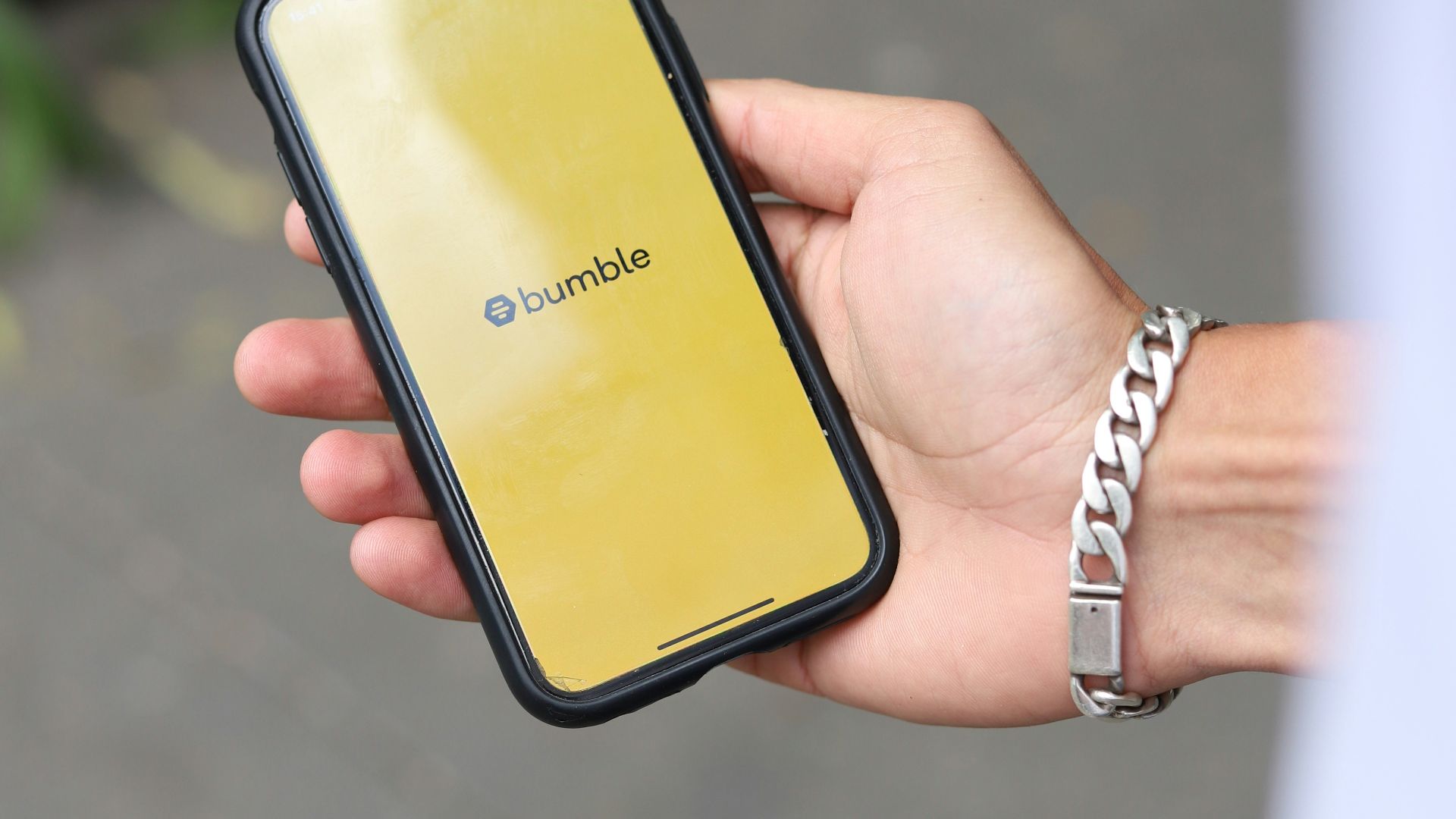 a person holding a cell phone in their hand