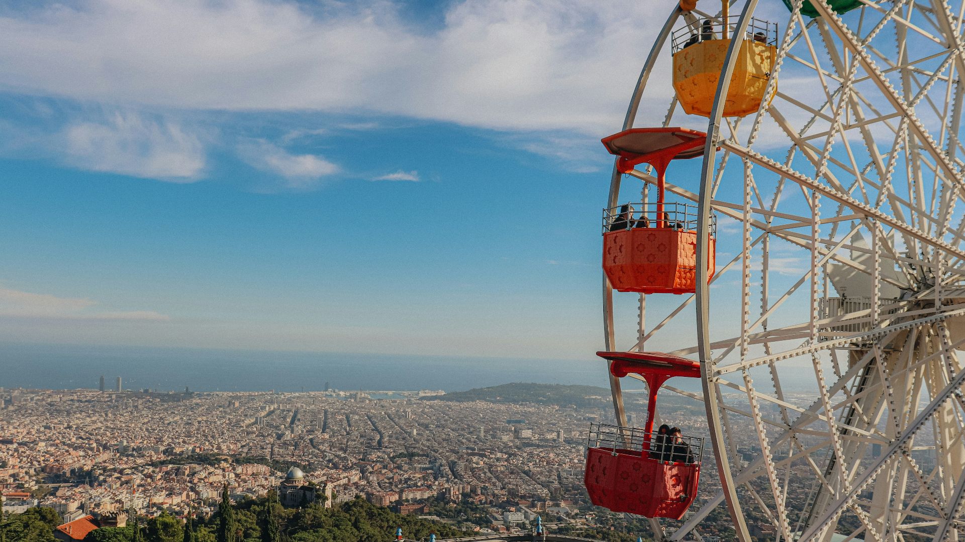 a ferris wheel overlooking the city of barcelona