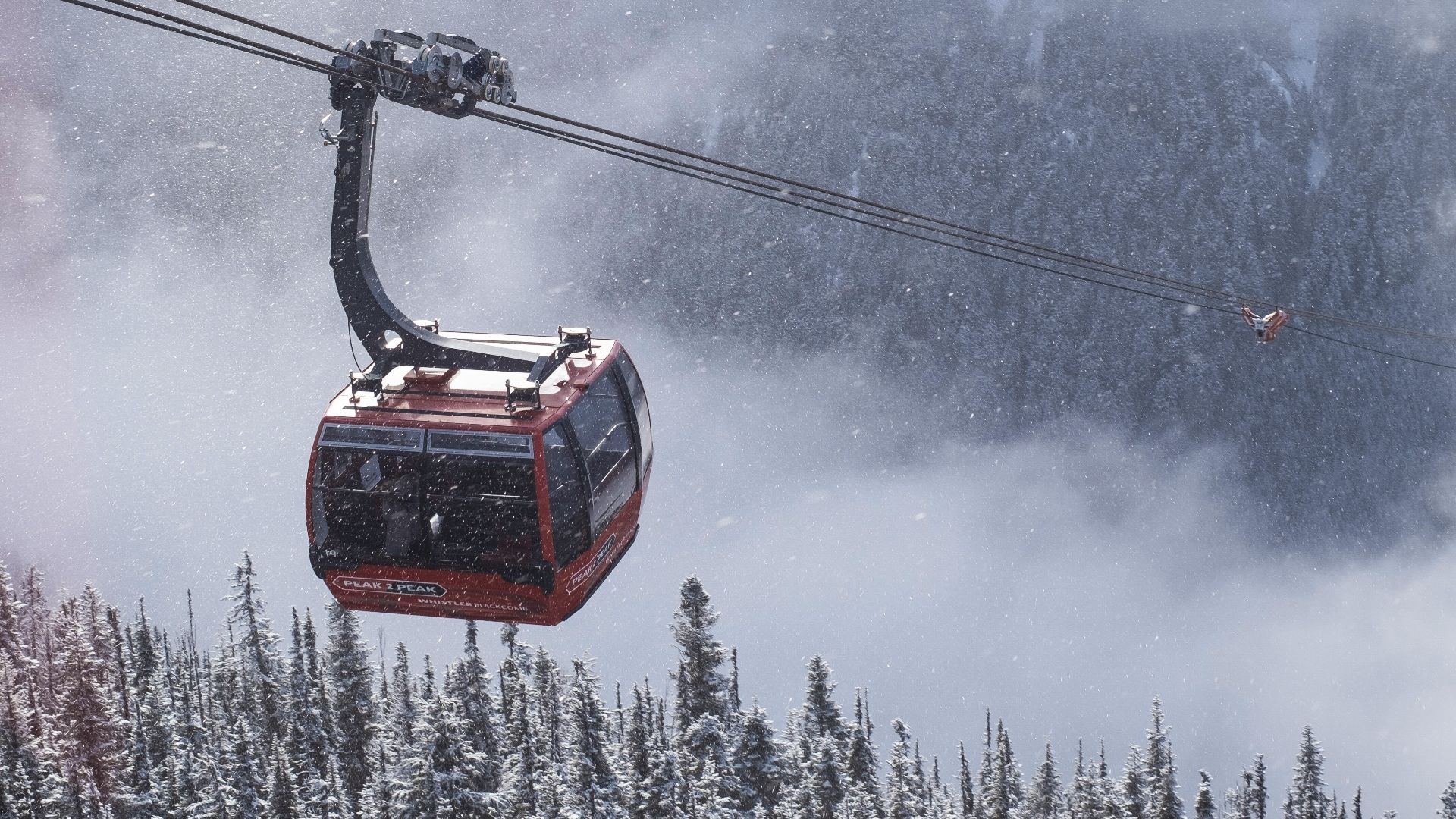 a gondola in the middle of a snowy mountain