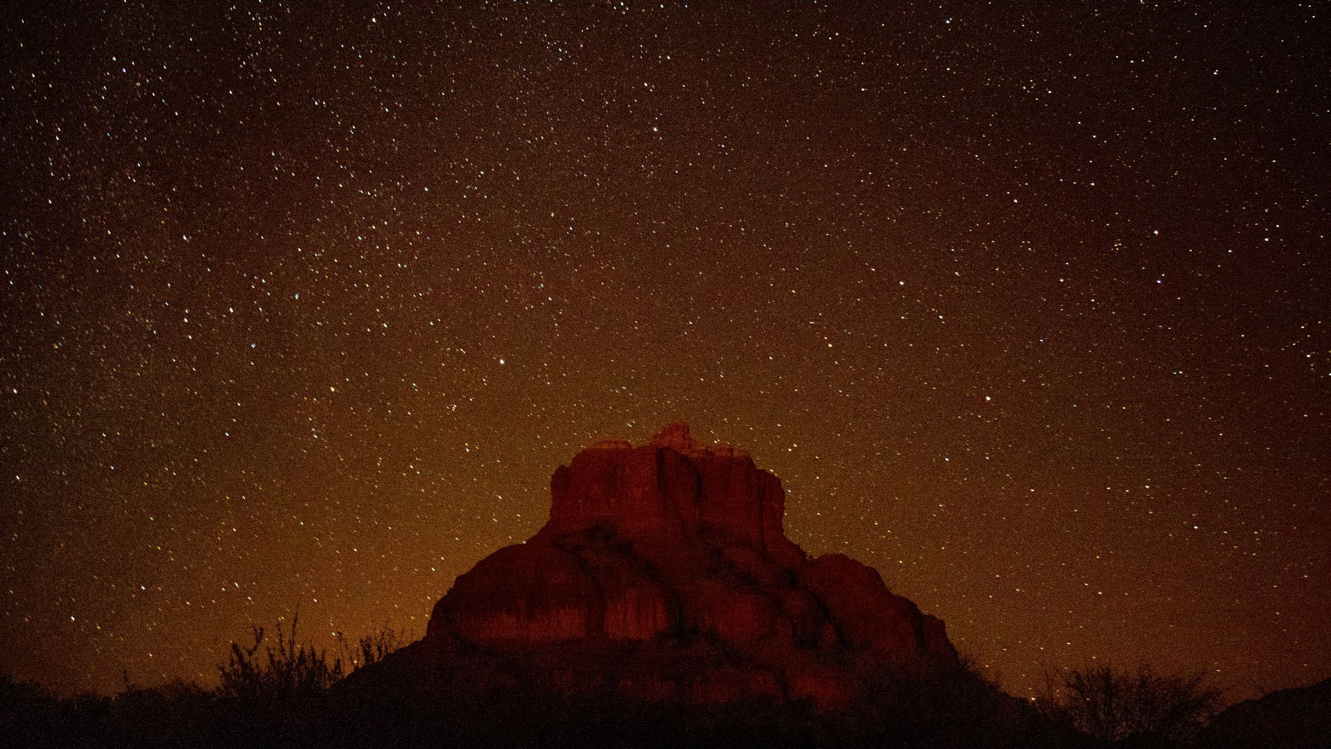 brown mountain under starry sky during nighttime in timelapse photography