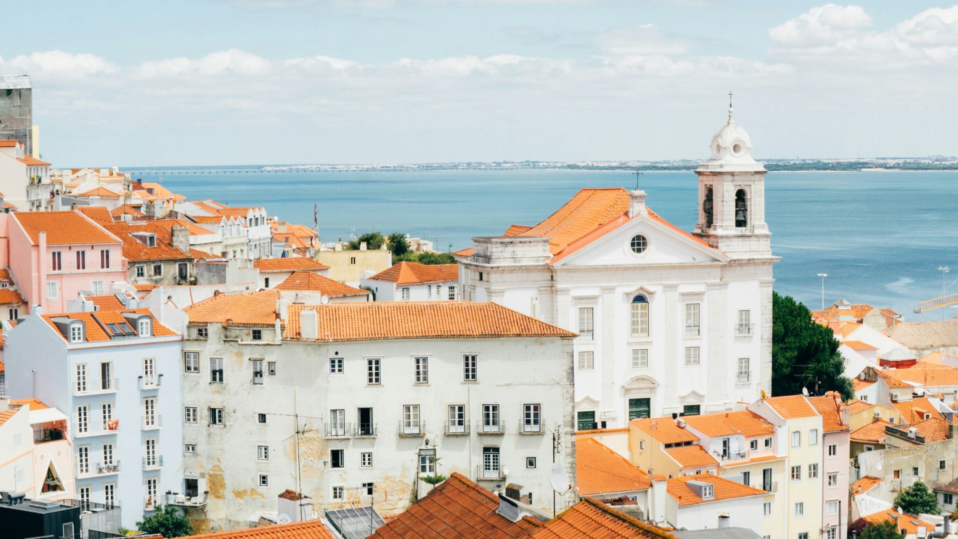landscape photography of orange roof houses near body of water