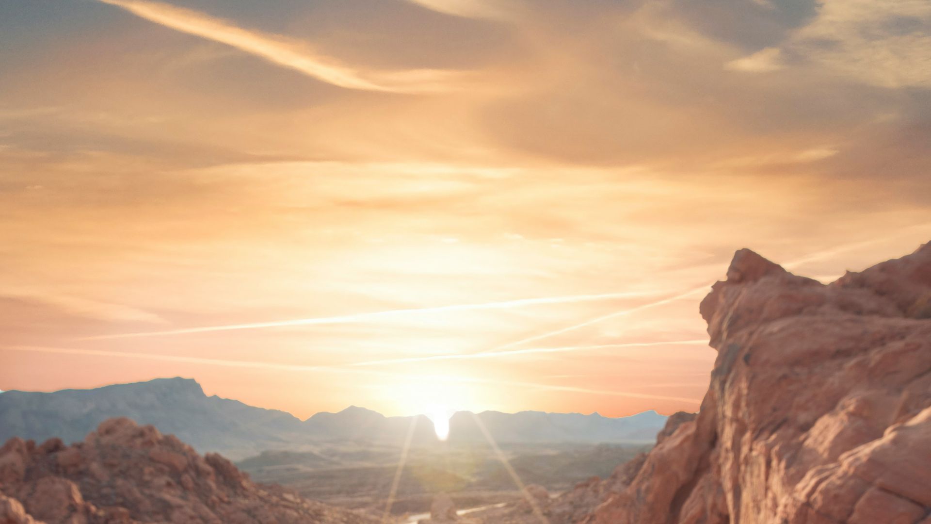 person sitting on rock formation cliff
