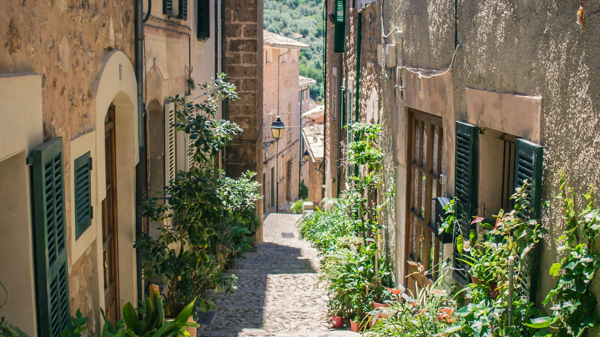 empty road near brown building during daytime