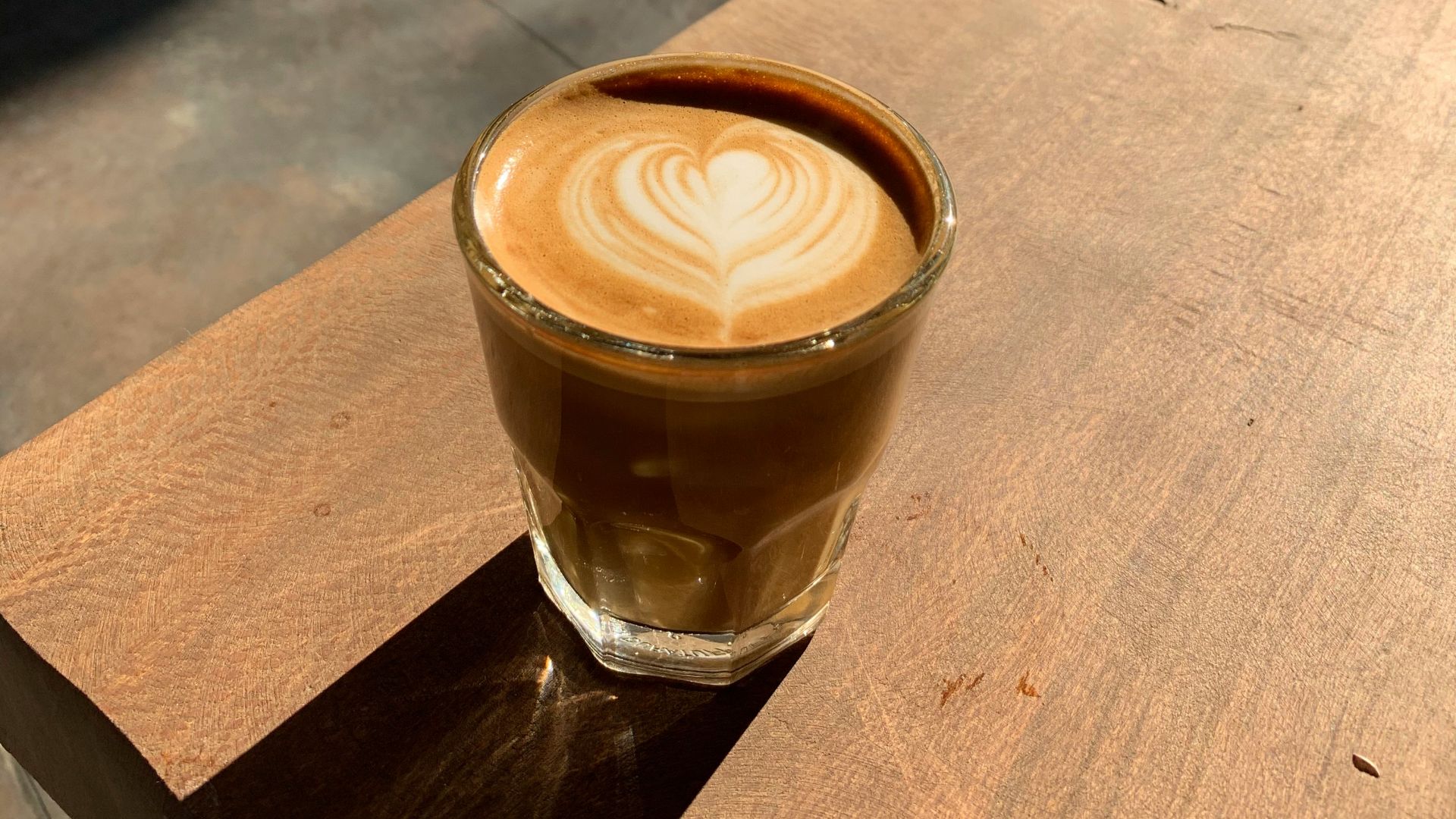 clear drinking glass on brown wooden table