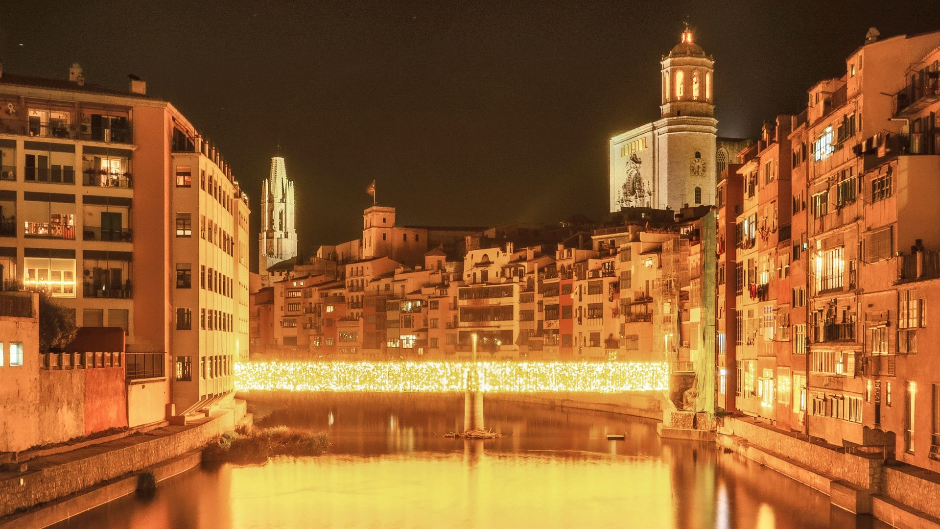 brown concrete building near river during night time