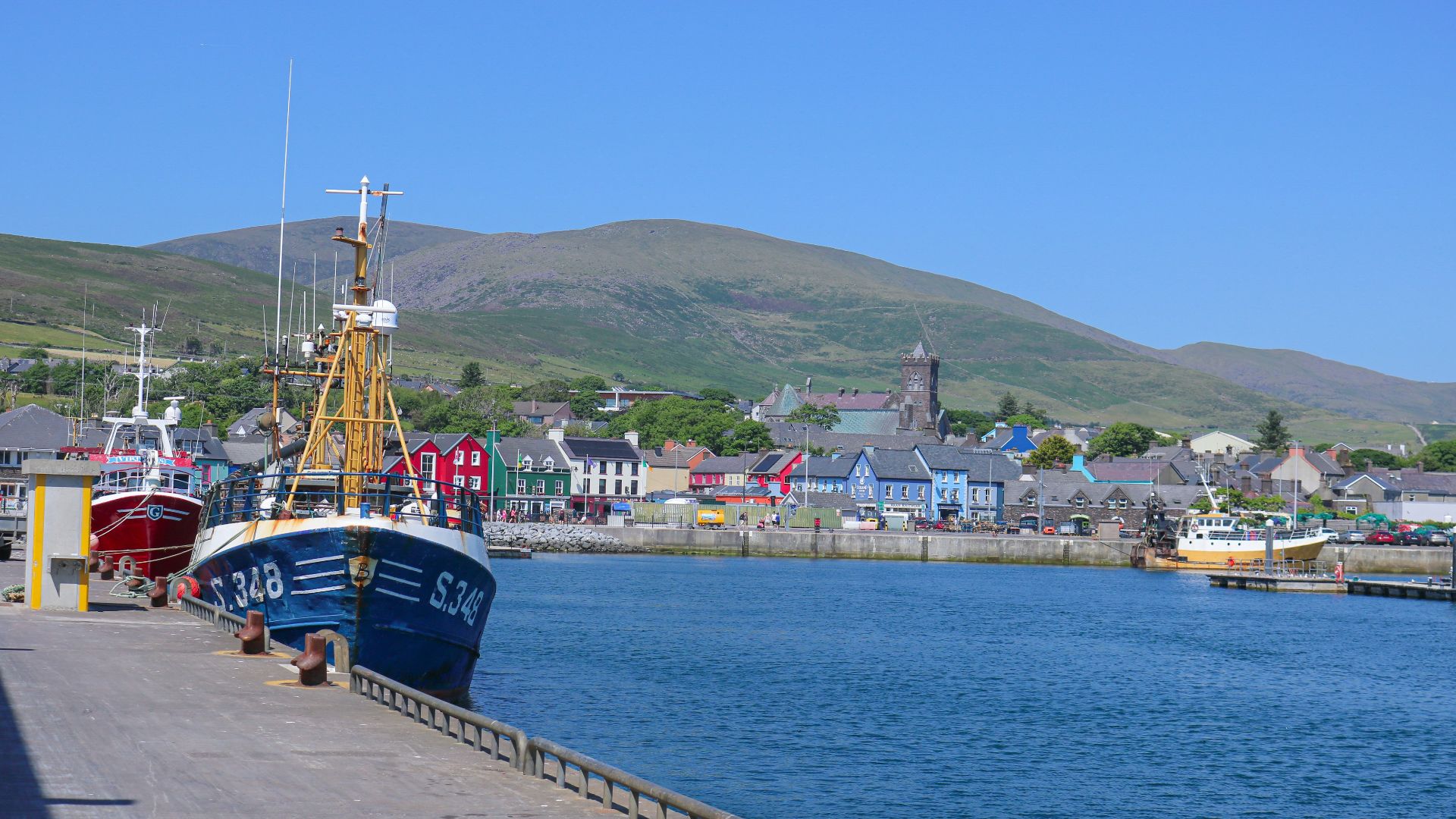 two boats docked at a pier in a harbor