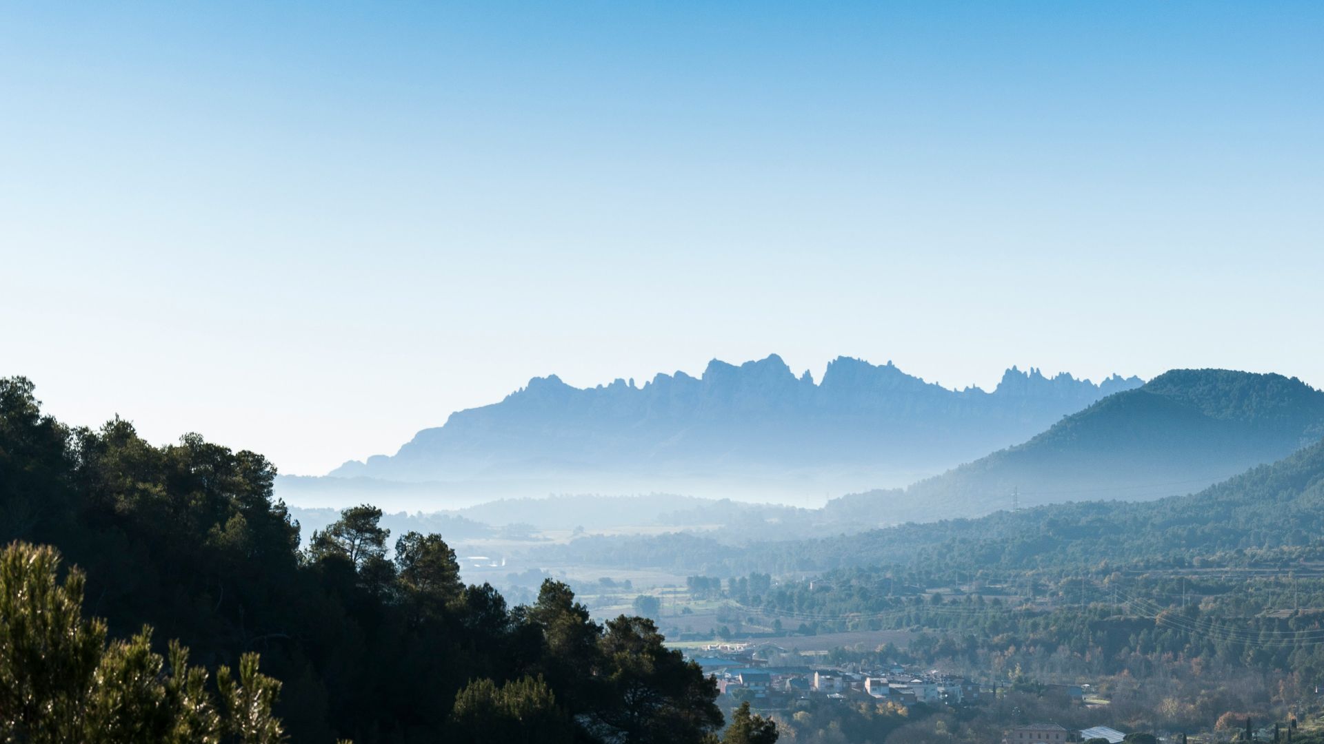 a view of a valley with mountains in the background