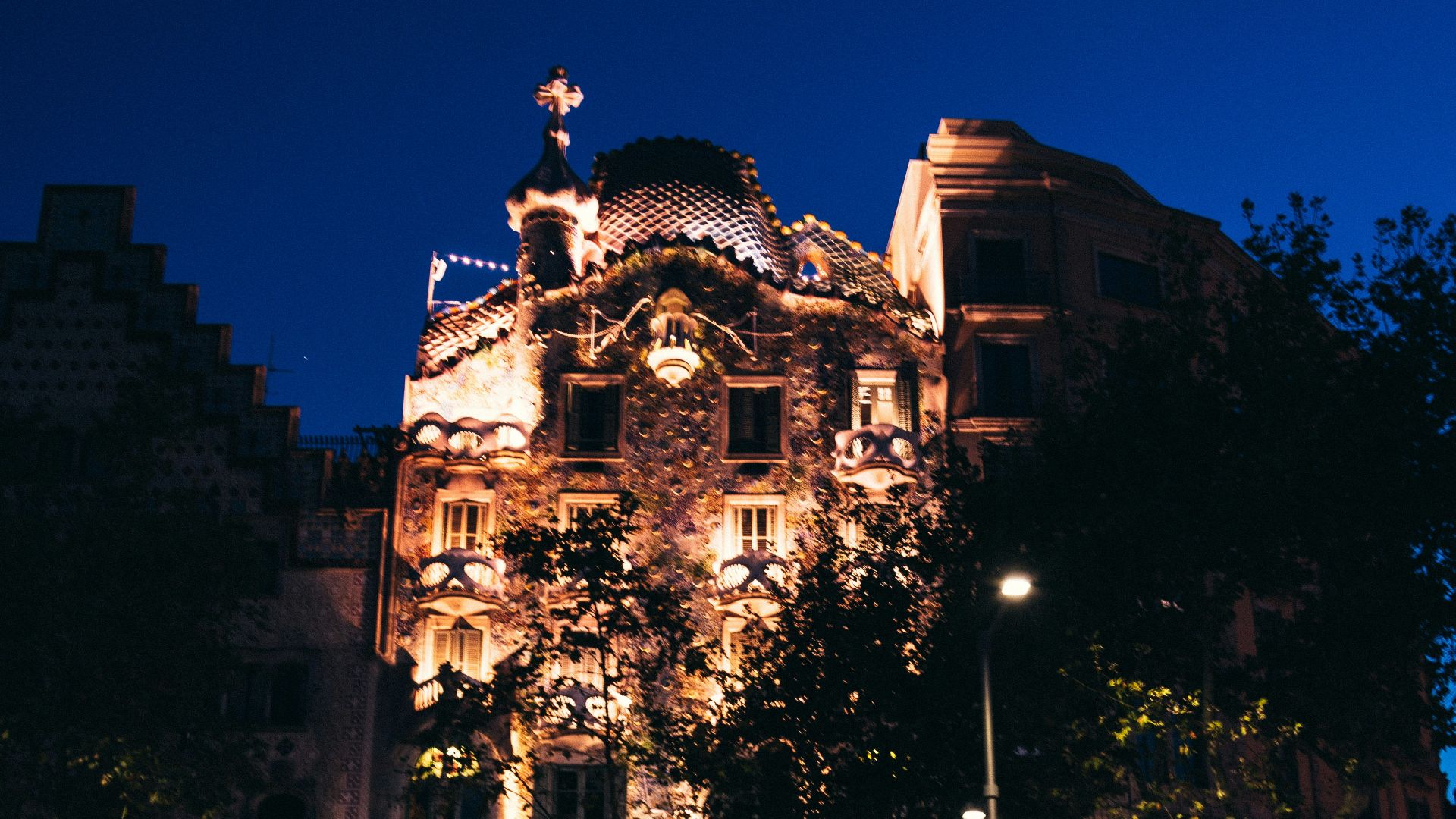 vehicles passing on brown concrete building at night