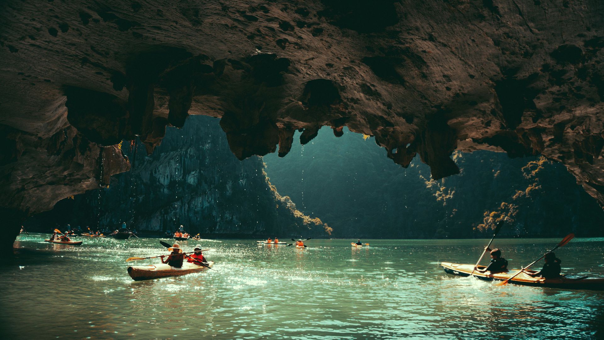 a group of people in canoes paddling through a cave
