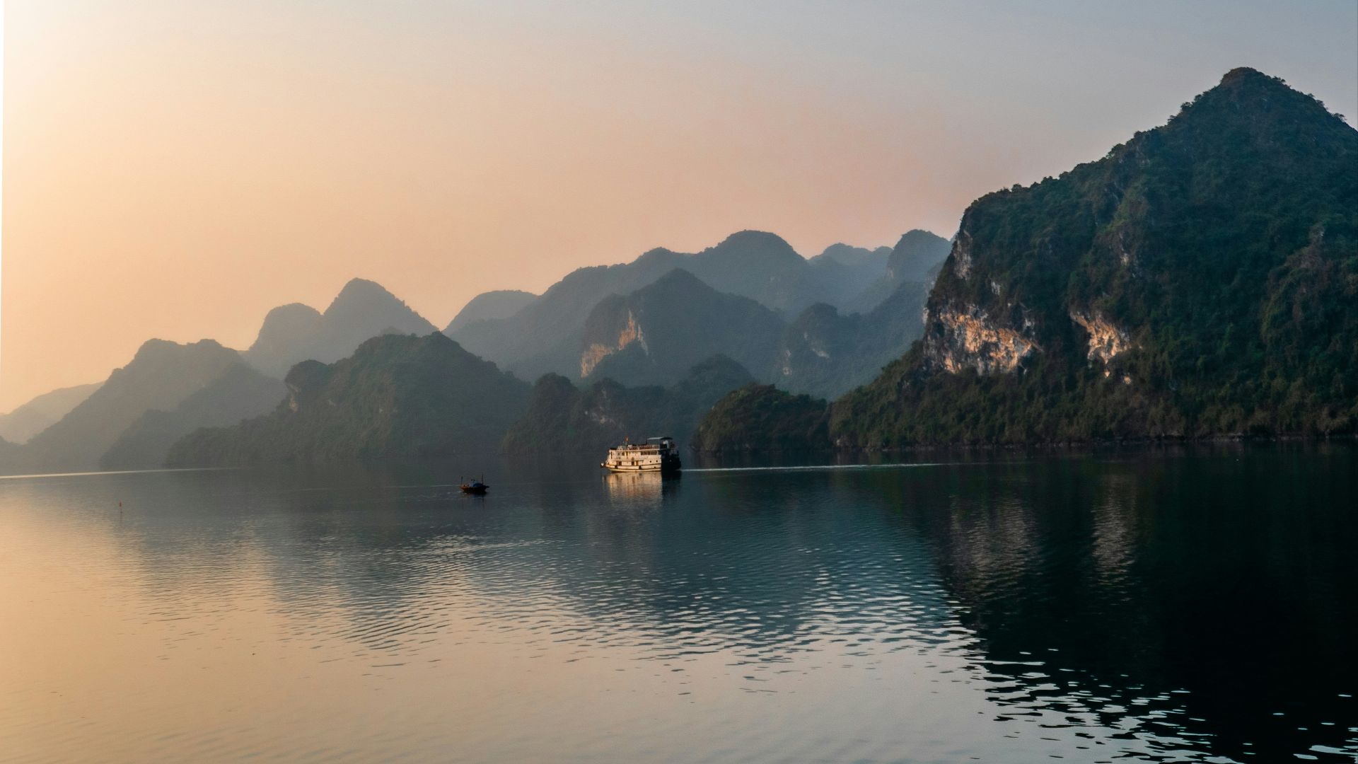 body of water near mountain during daytime