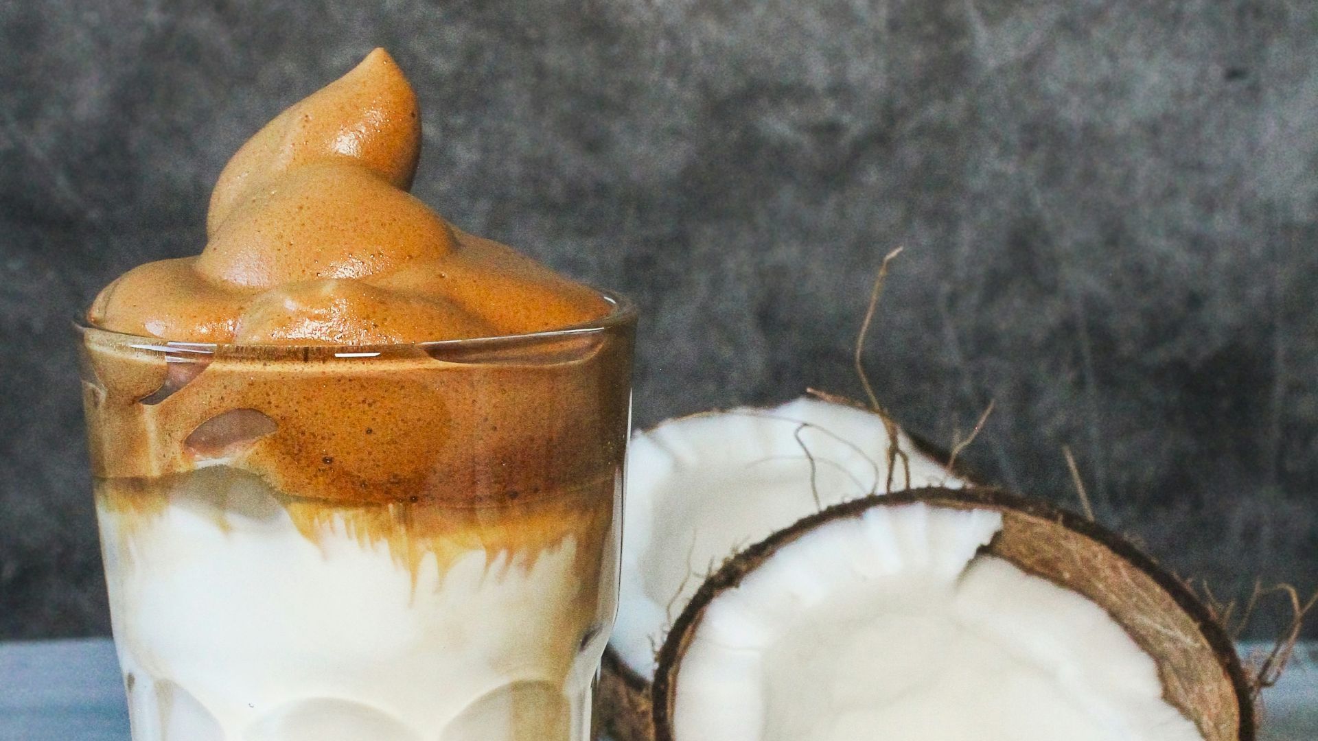 clear drinking glass with white liquid and orange slice