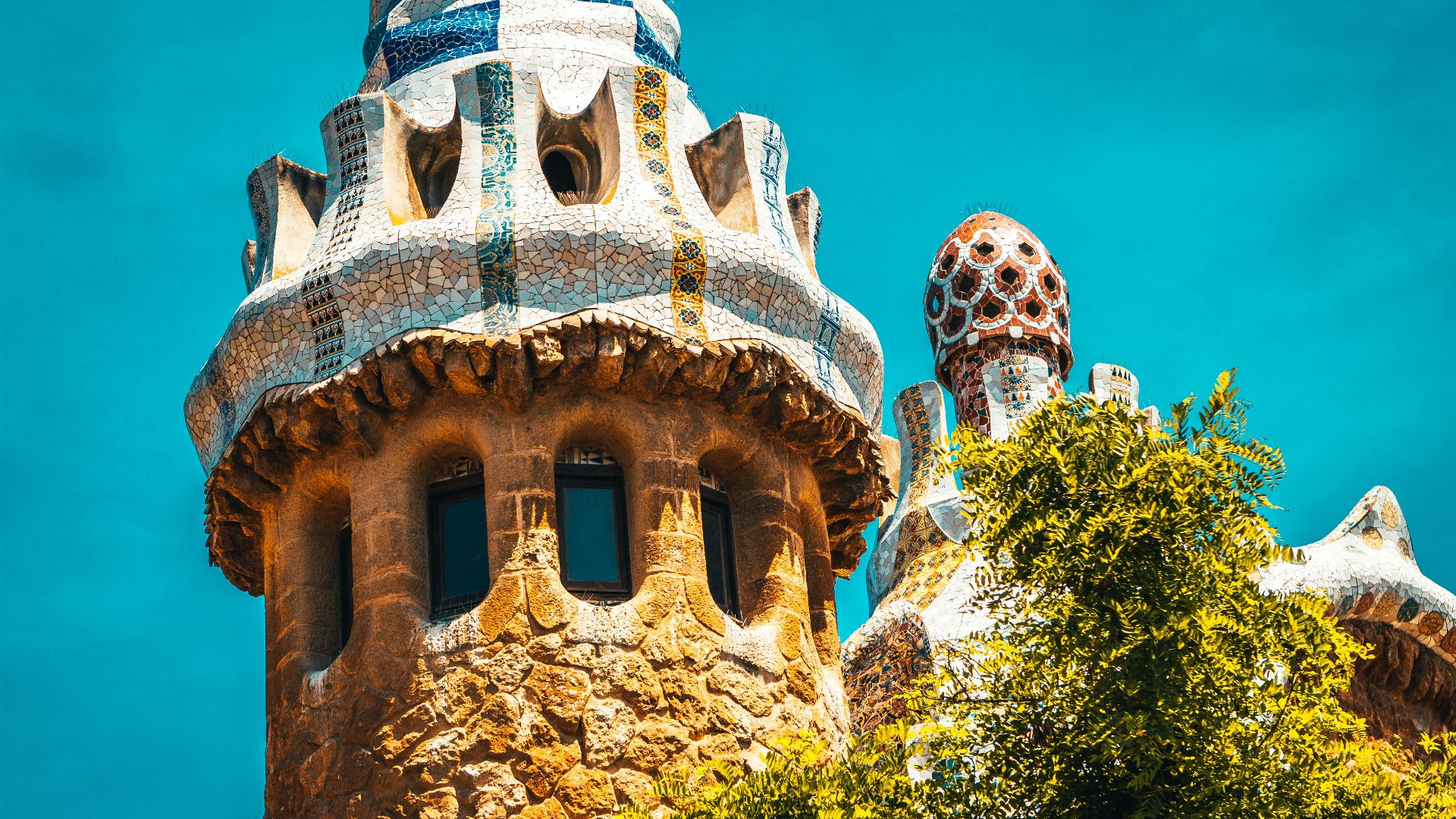 brown and white concrete building near green trees during daytime