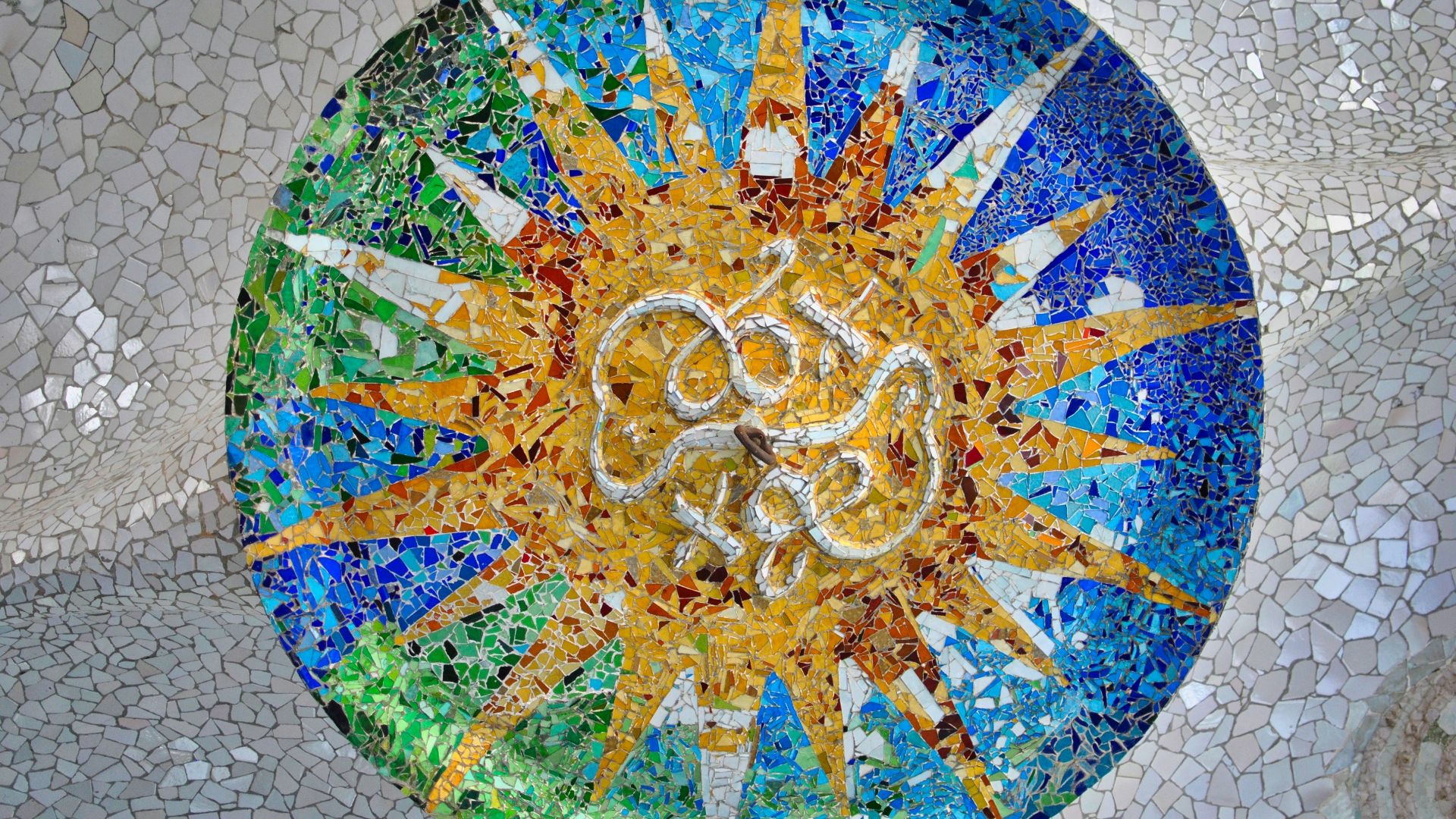 a mosaic table with a sun design on it