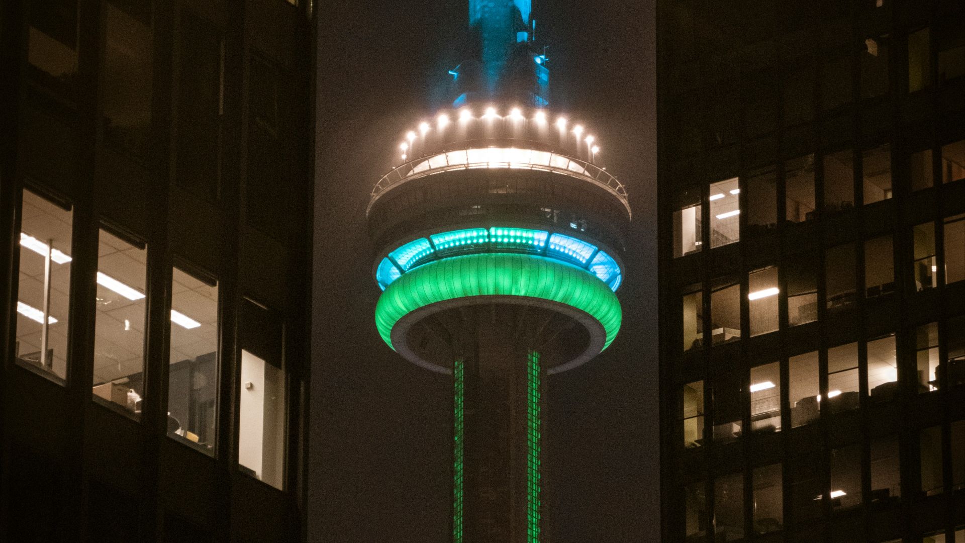 lighted blue and green tower during nighttime