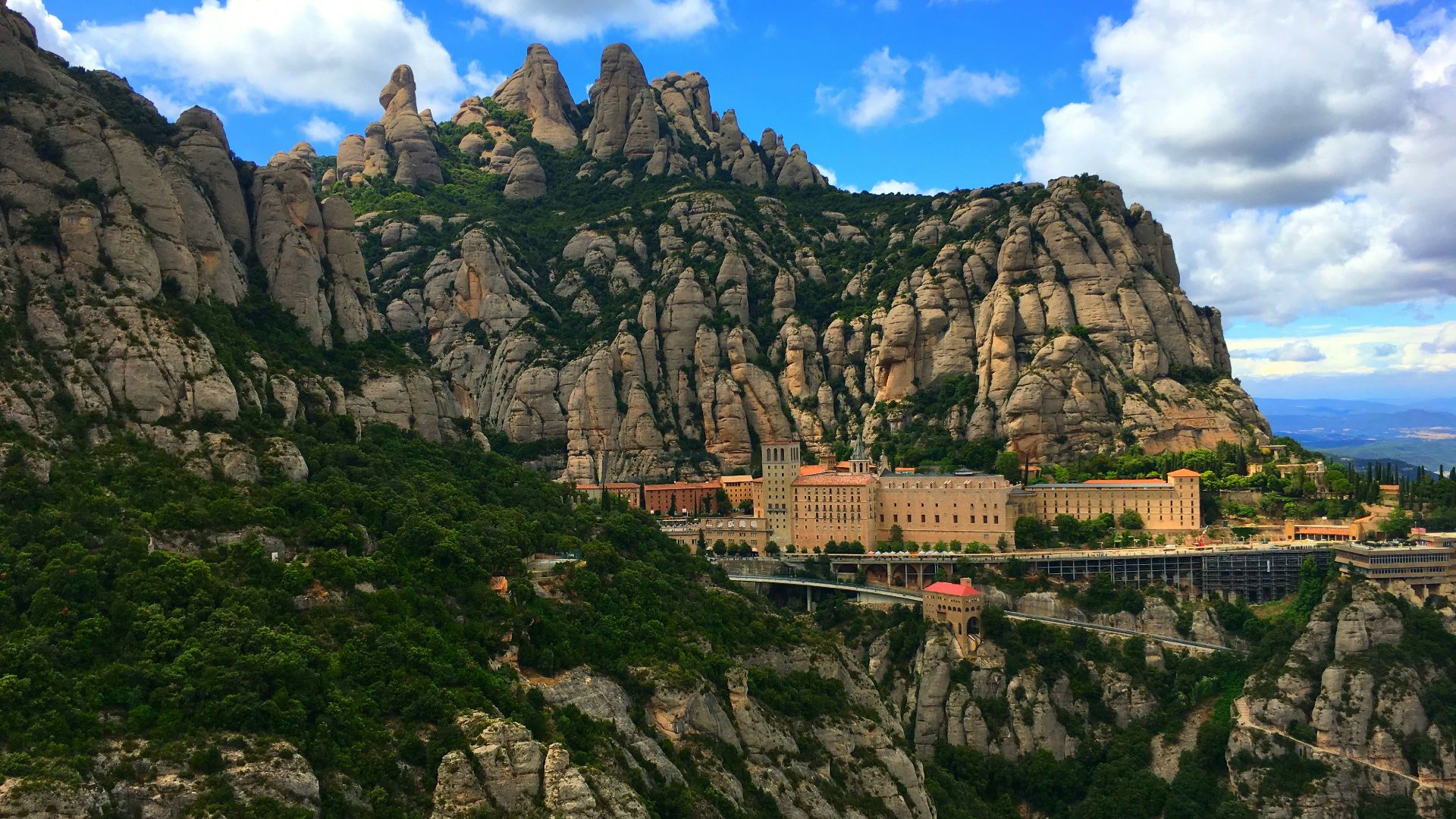 brown concrete building near mountain
