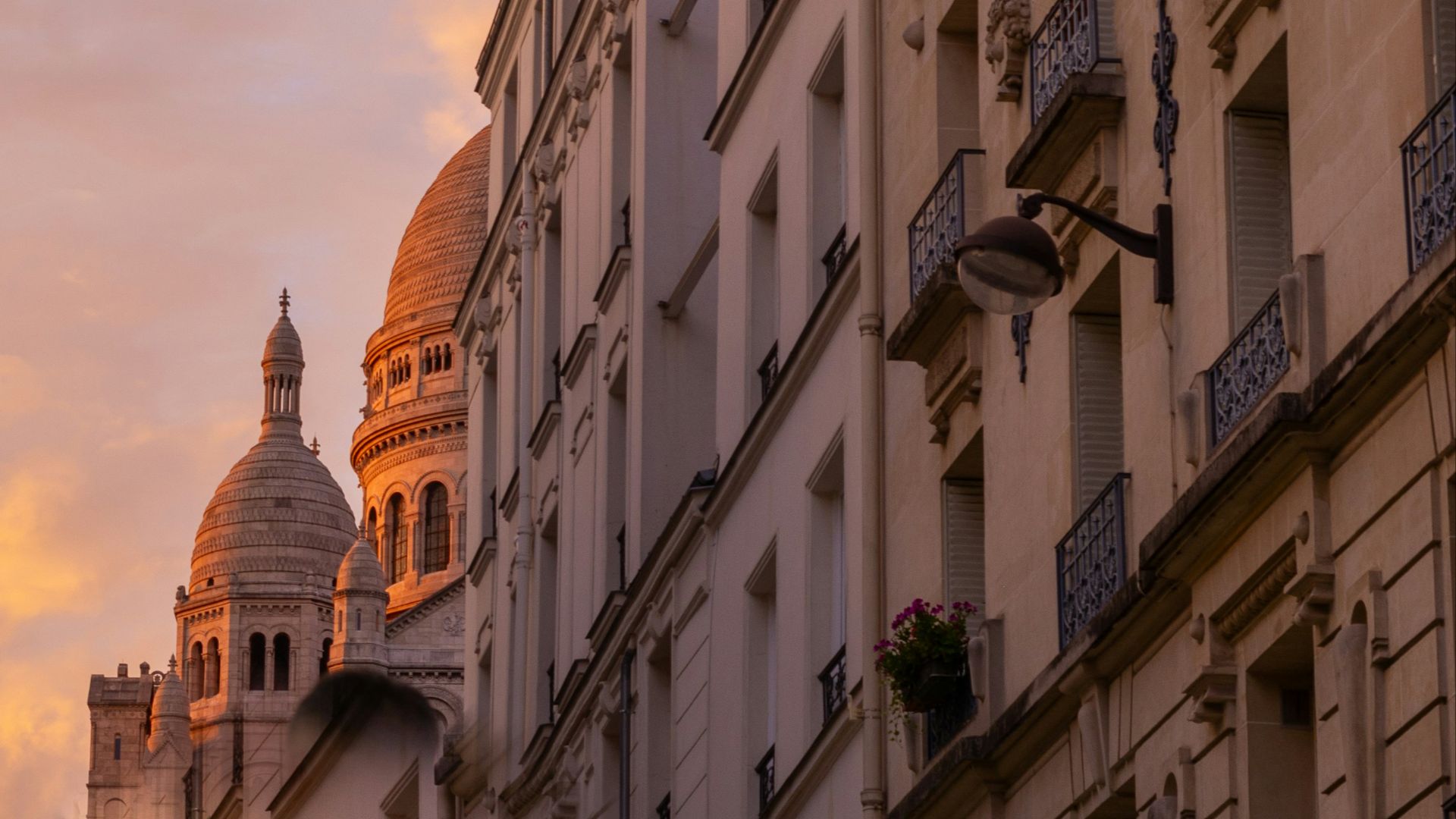 a row of buildings with a clock tower in the background