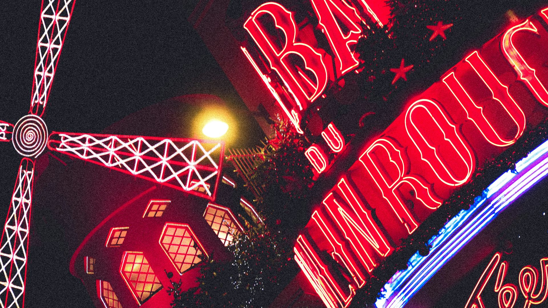 a red and white sign and some buildings and lights