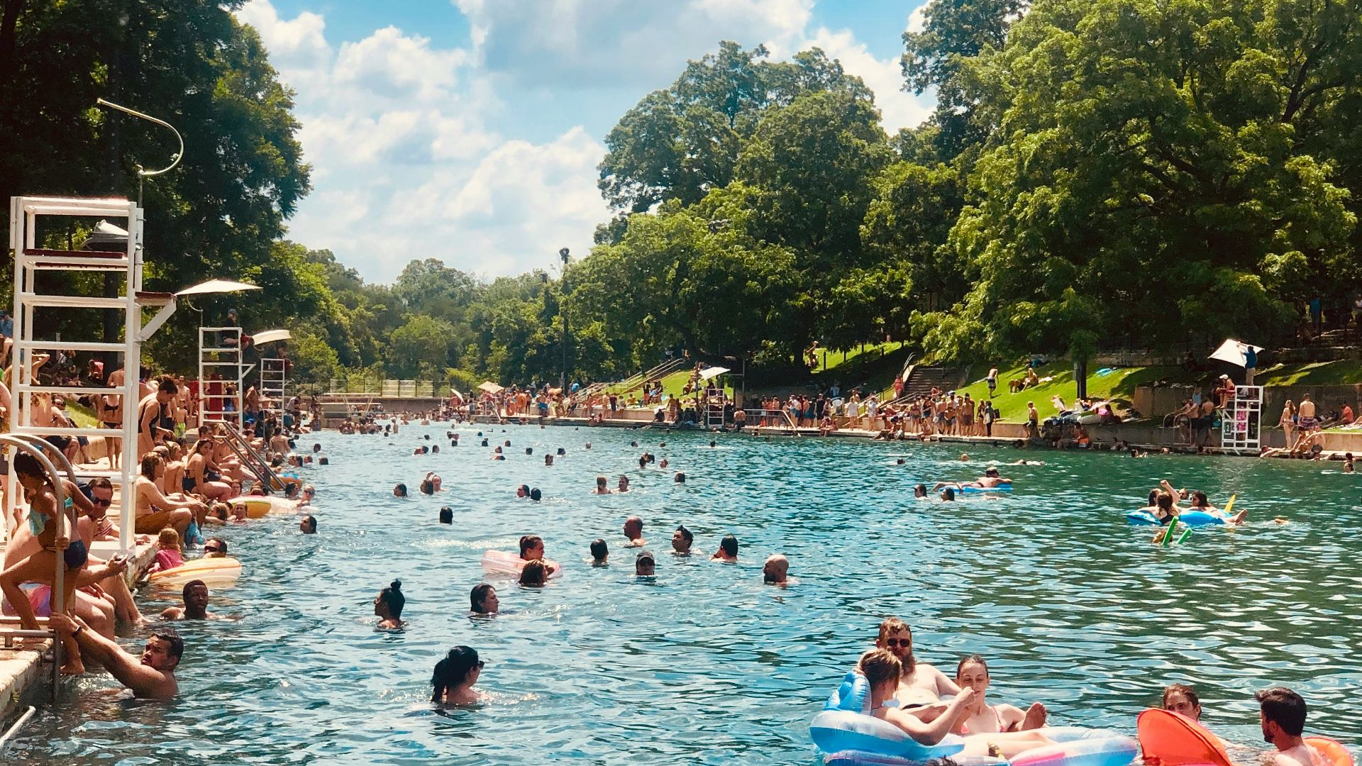 people on river under clear blue sky