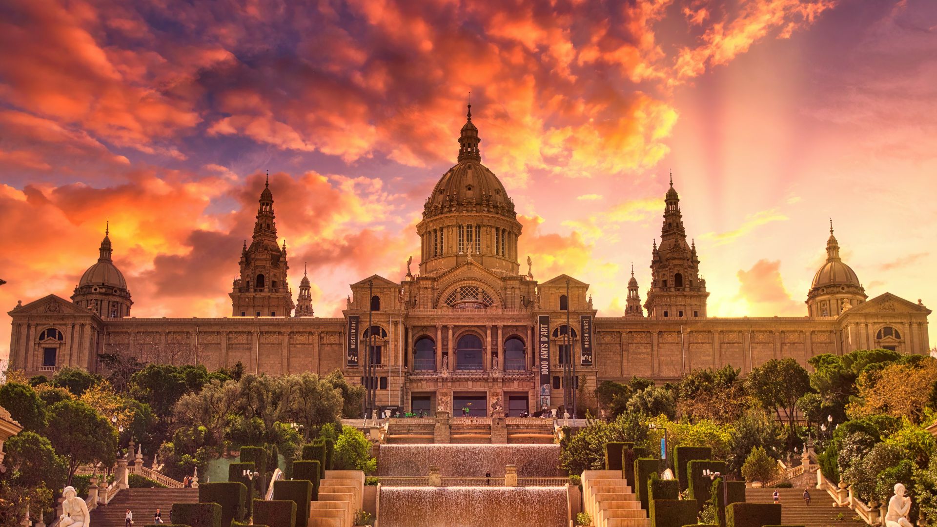 people sitting on bench near building during sunset