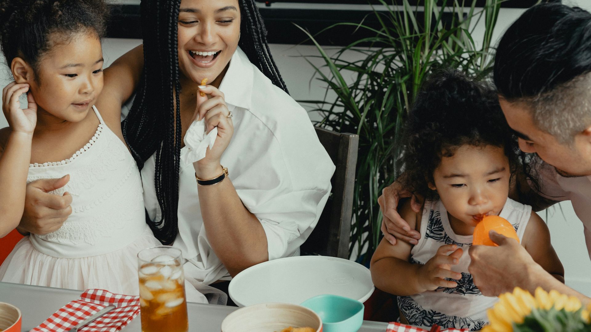 woman in white sleeveless dress sitting beside woman in white sleeveless dress