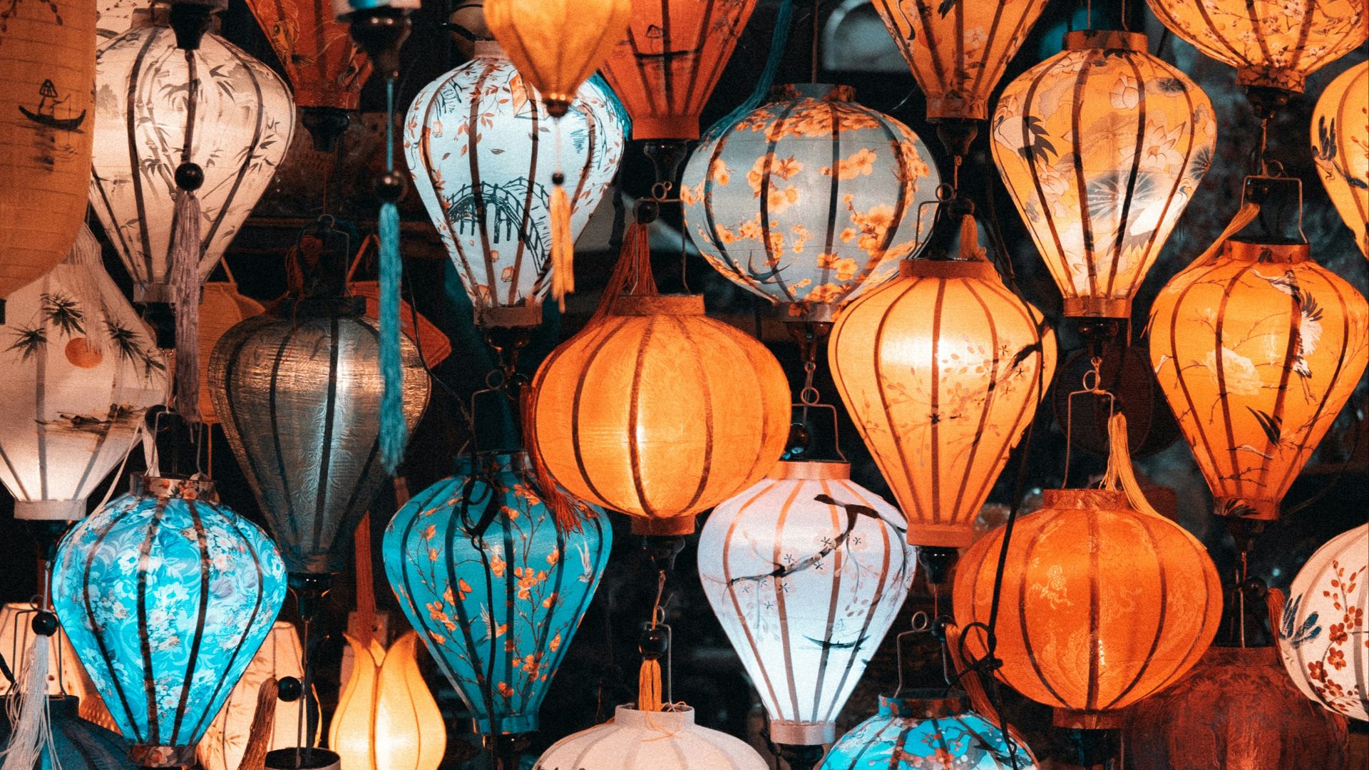 A bunch of different colored lanterns on display