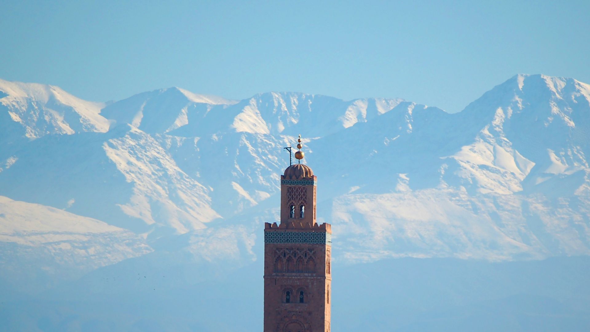 brown concrete building near mountain during daytime