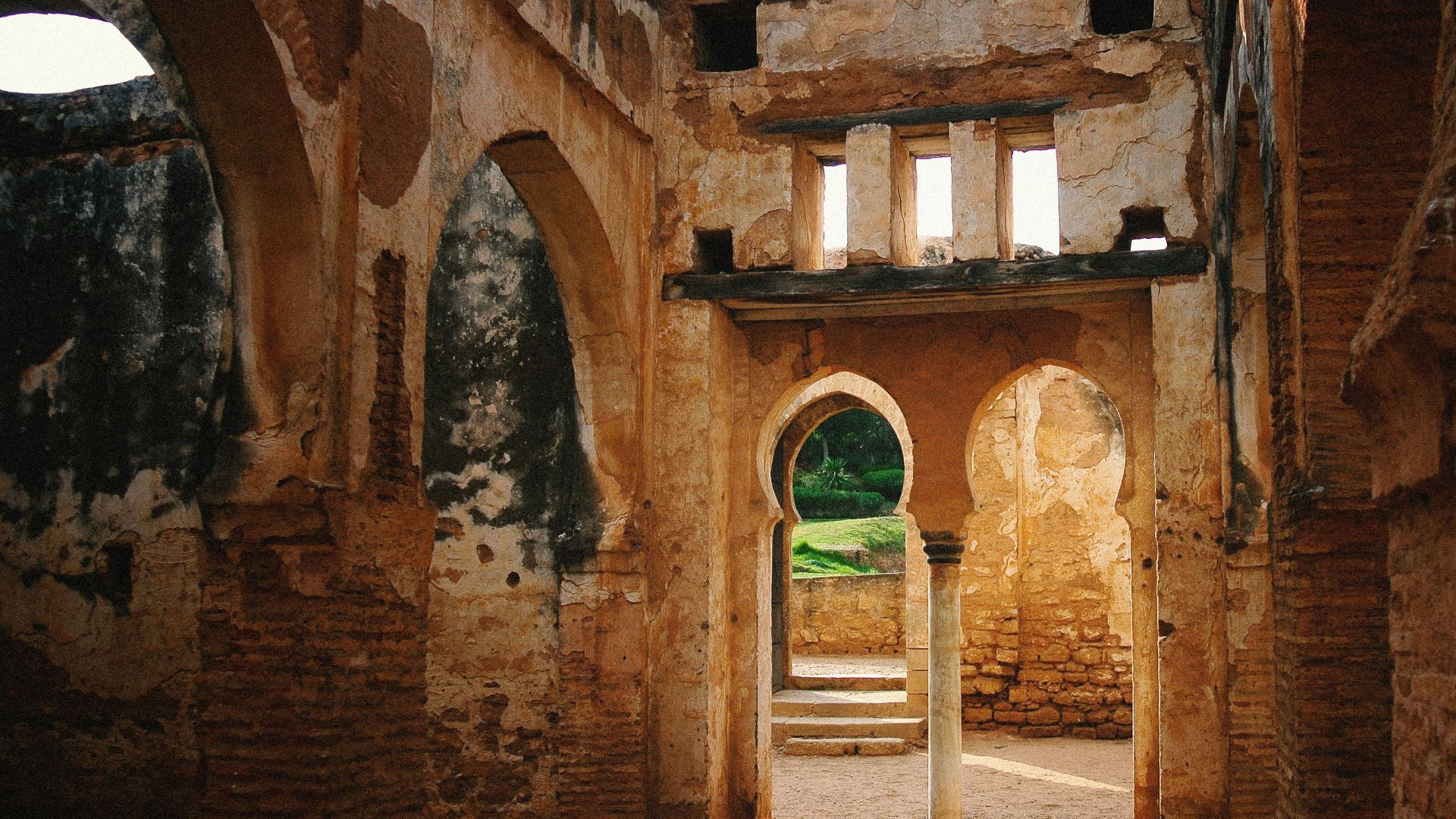 a doorway in an old building with stone walls and arches