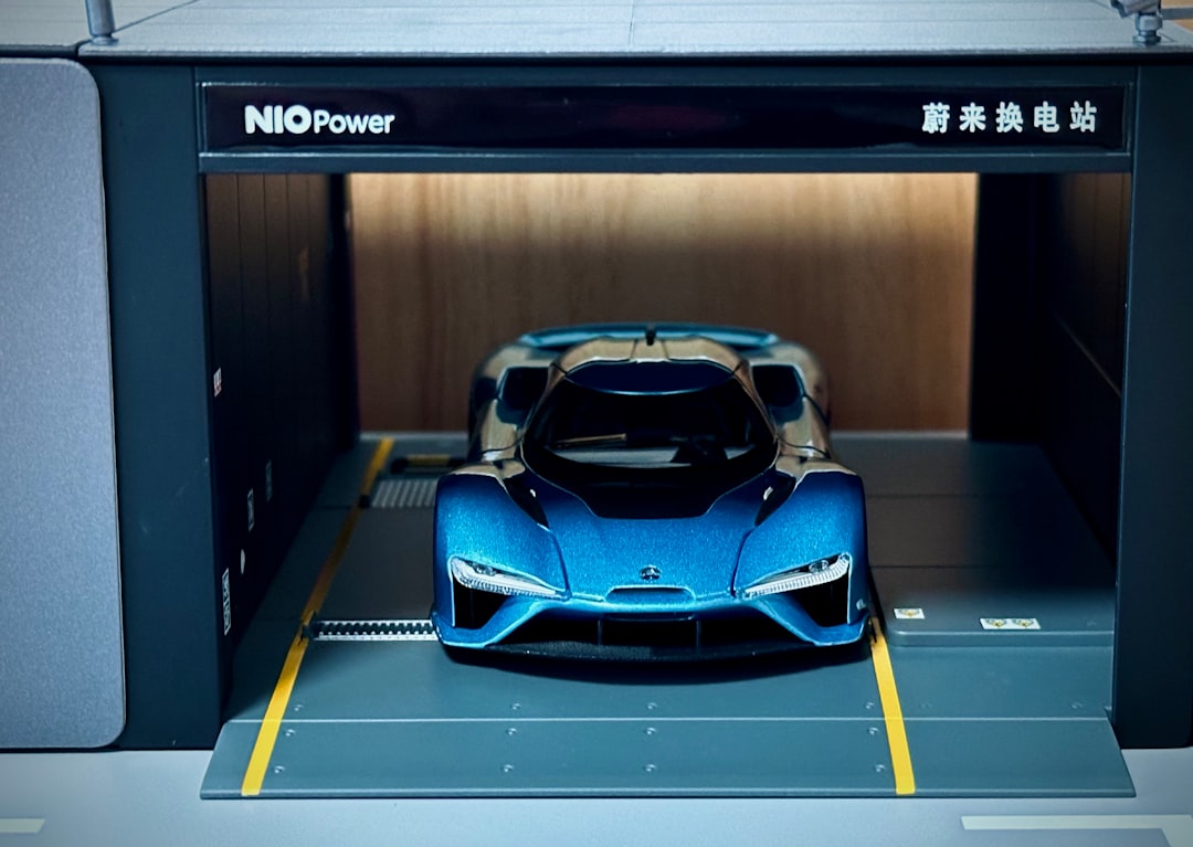 A blue sports car is parked in a garage
