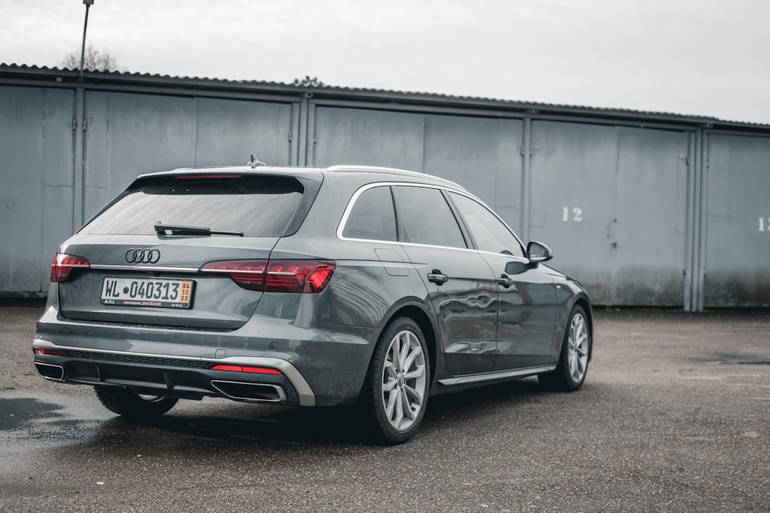 a grey car parked in front of a building