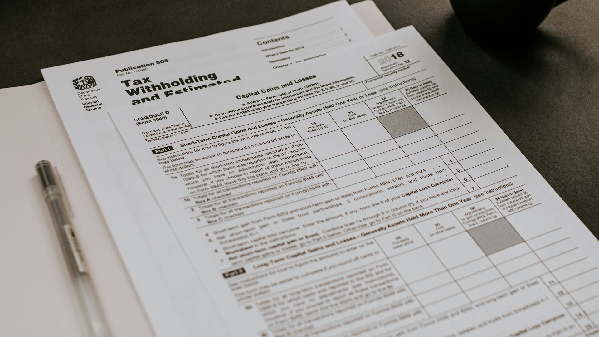 black ceramic mug beside white printer paper