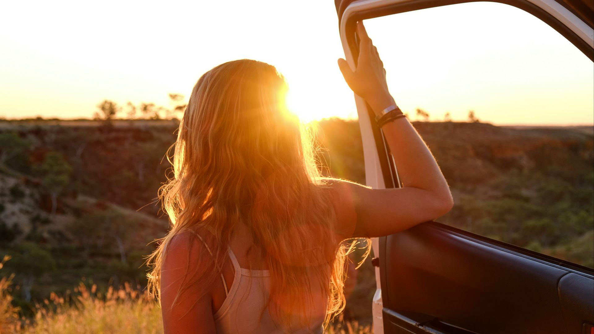 woman holding vehicle door