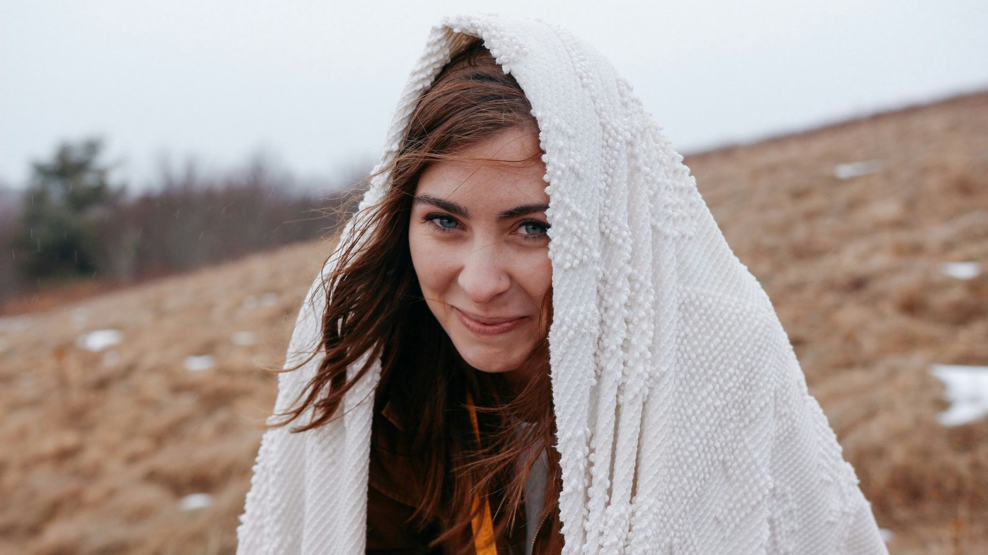 smiling woman wrapped with white headscarf